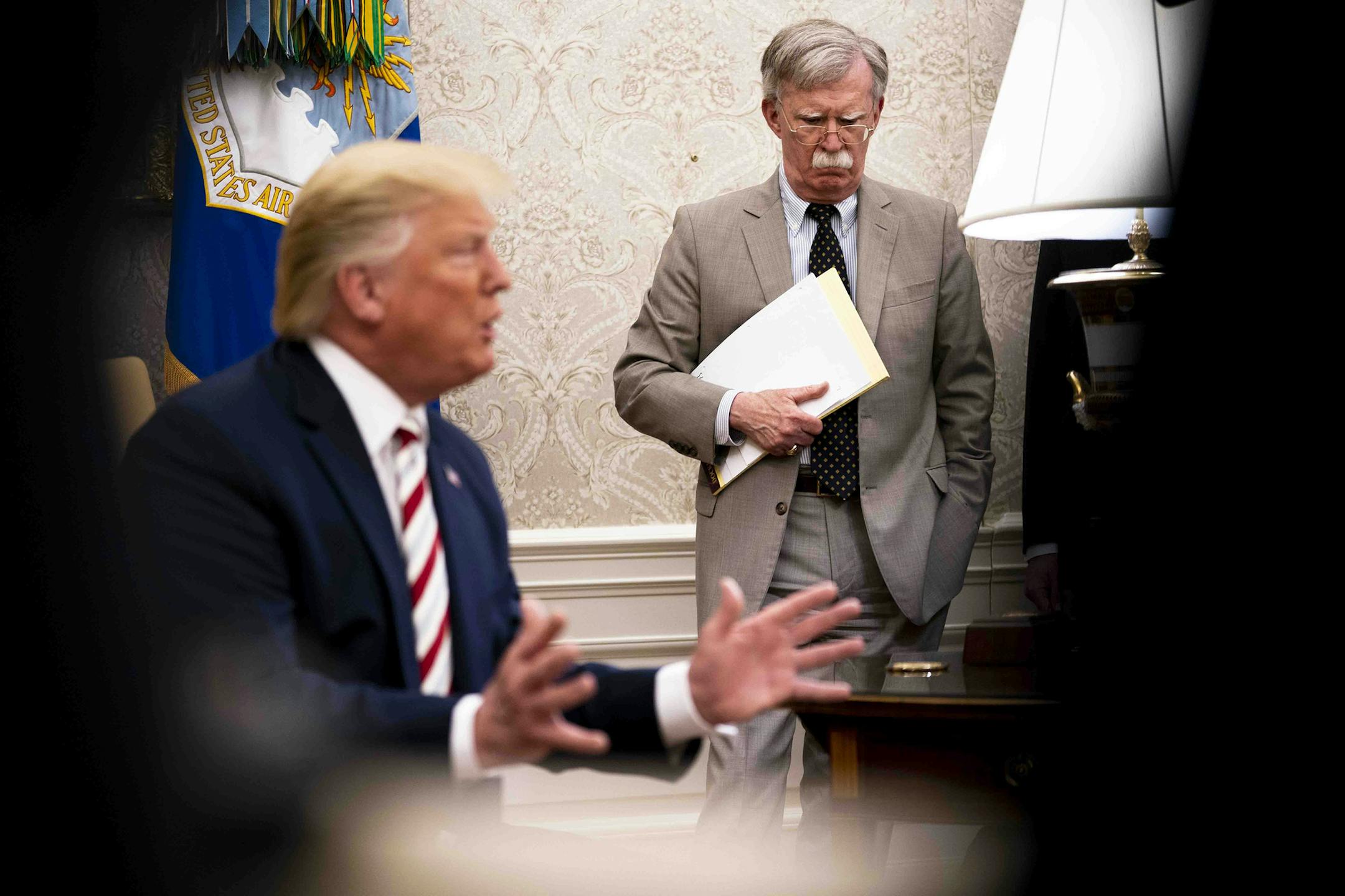 FILE -- John Bolton, then the national security adviser, watches as President Donald Trump hosts the Romanian president in the Oval Office, at the White House in Washington, Aug. 20, 2019. Bolton is among the current and former officials whom Democrats want to call as a witness, and if senators vote to subpoena testimony for the impeachment trial, the president may not be able to block or delay a willing witness. (Doug Mills/The New York Times)