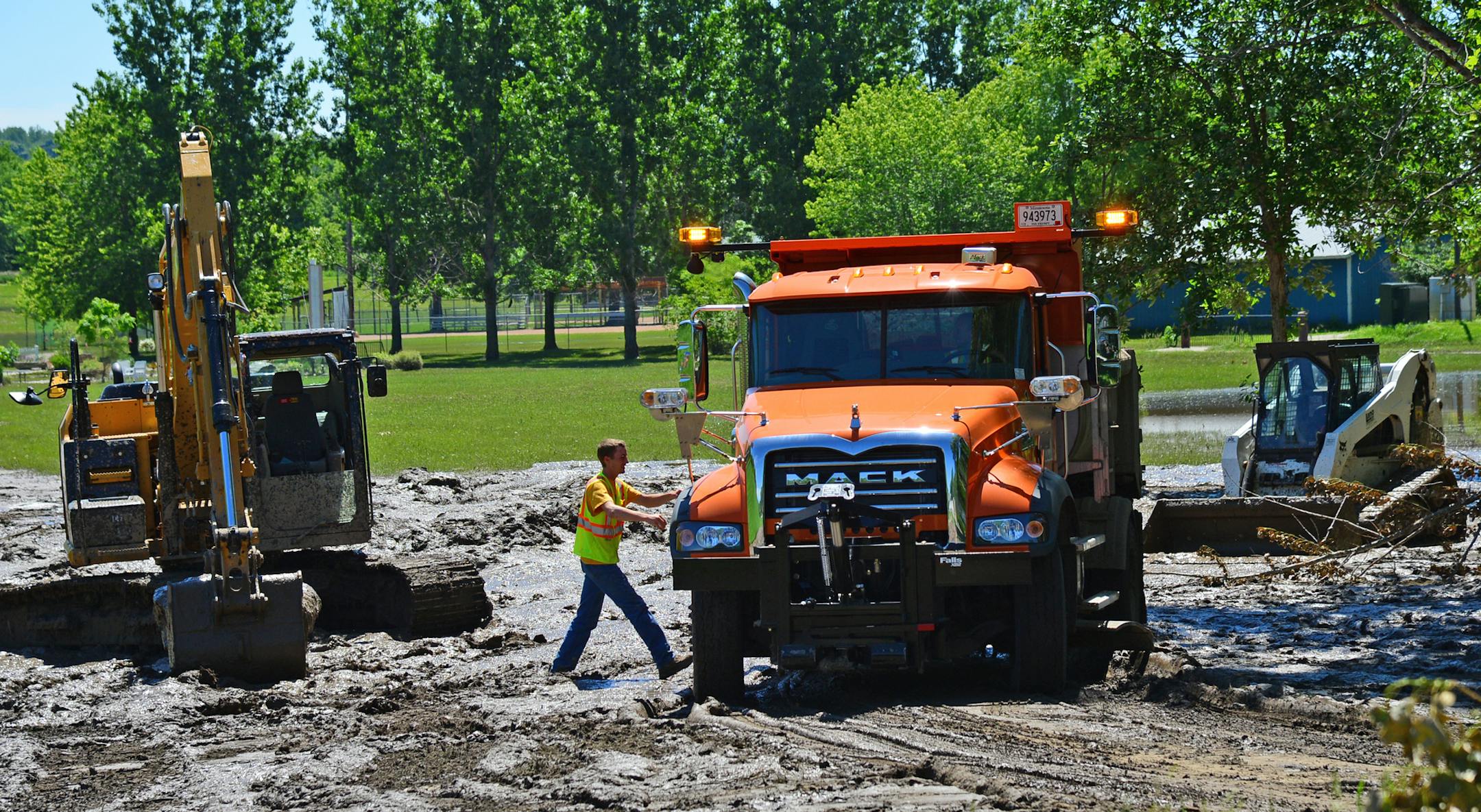 Crews from the town of Henderson have been clearing slurry of mud that washed into town during the flood. ]Flooding and the aftermath of heavy rains are still being felt in Henderson, several roads are closed by mudslides and flooding..Richard.Sennott@startribune.com Richard Sennott/Star Tribune Henderson Minn. Saturday 6/21/2014) ** (cq)