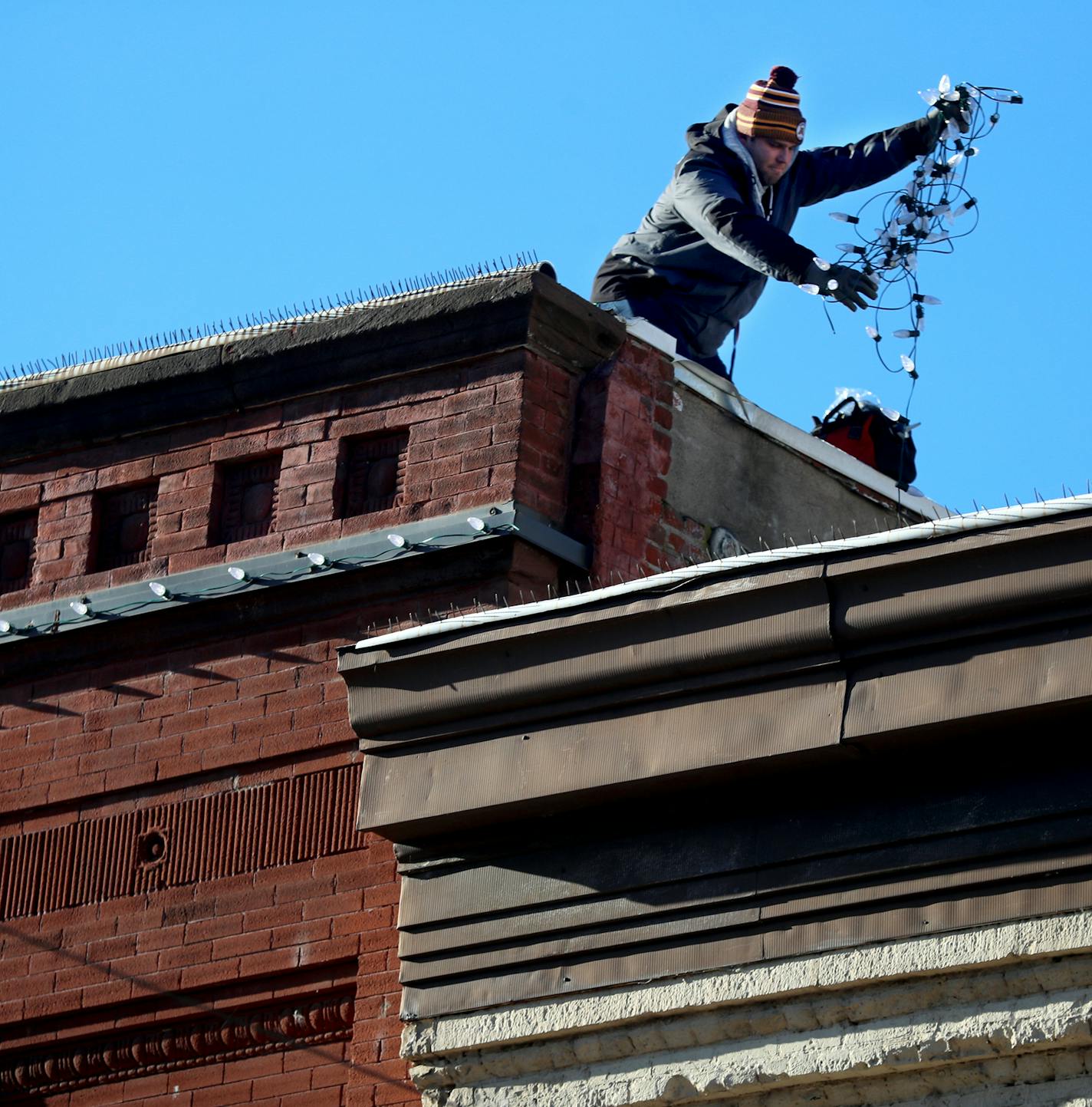 Chris Martin of Holiday Light and Design strung lights Tuesday in downtown Stillwater in preparation for the holidays.