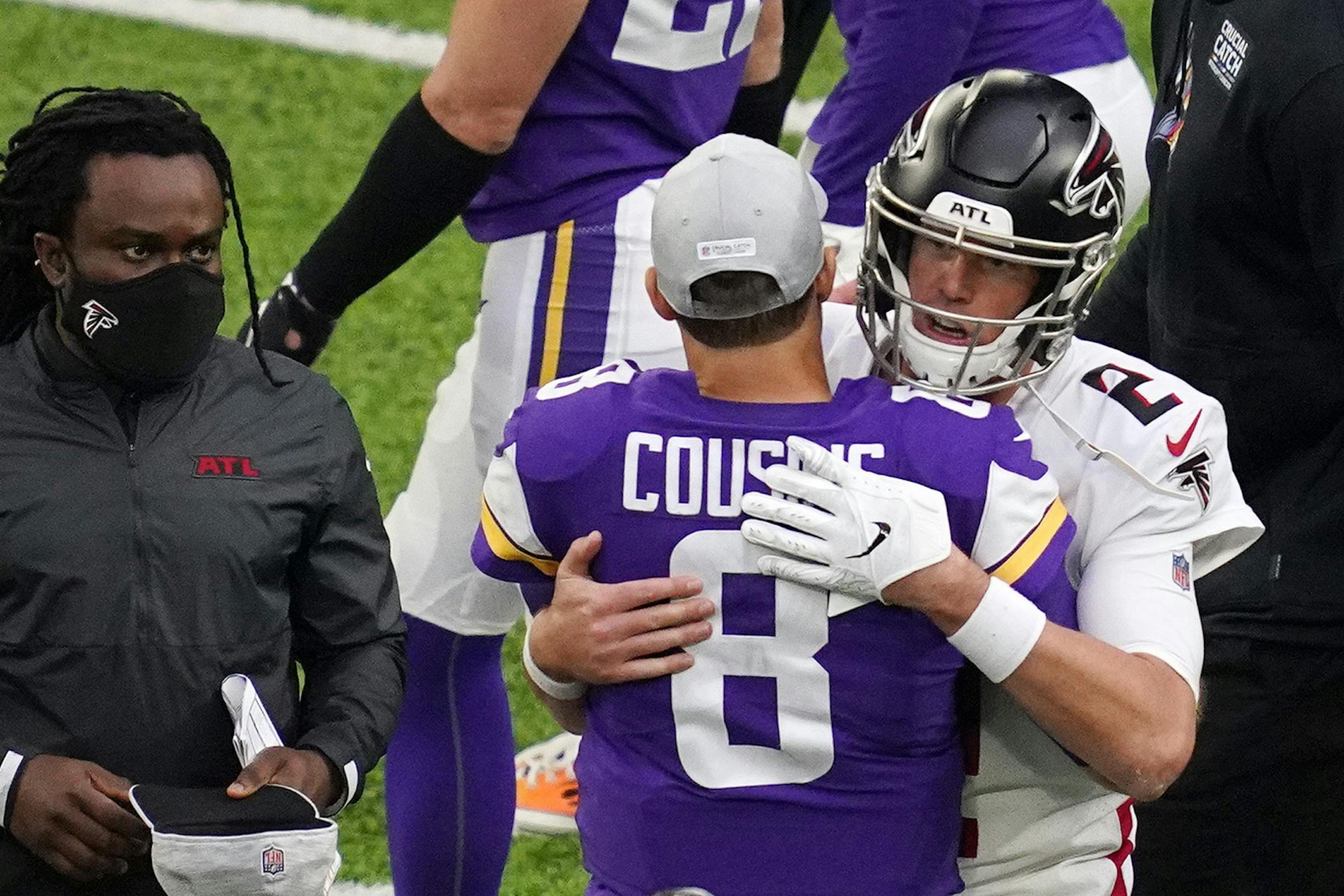 Minnesota Vikings quarterback Kirk Cousins (8) gave a hug to Atlanta Falcons quarterback Matt Ryan (2) at the end of the fourth quarter.