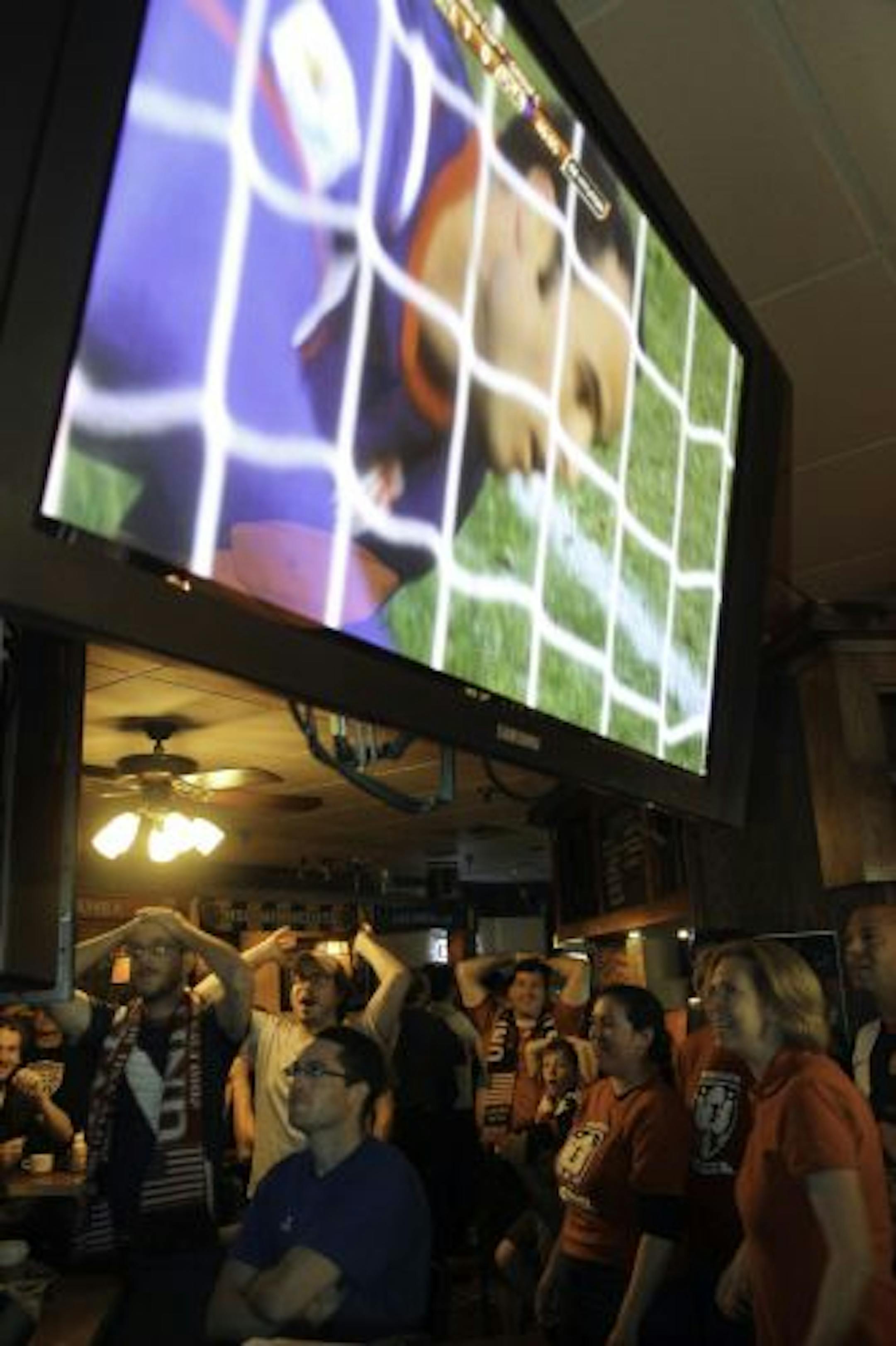 Fans at Sweetwater Bar & Grille in St. Paul reacted as they watched the United States play Slovenia.