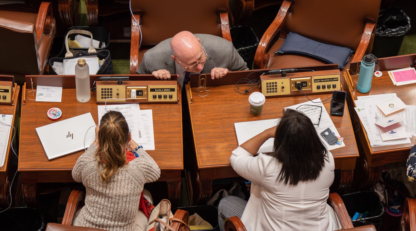 Legislators talk in State Capitol.