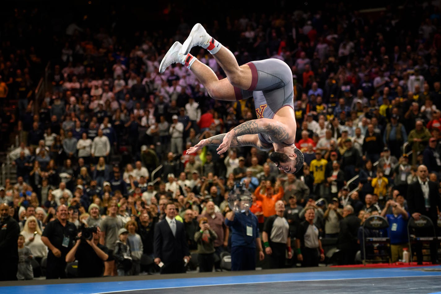 Minnesota's Gable Steveson celebrates with a backflip after defeating Arizona State 's Cohlton Schultz during their heavyweight match in the finals of the NCAA wrestling championships