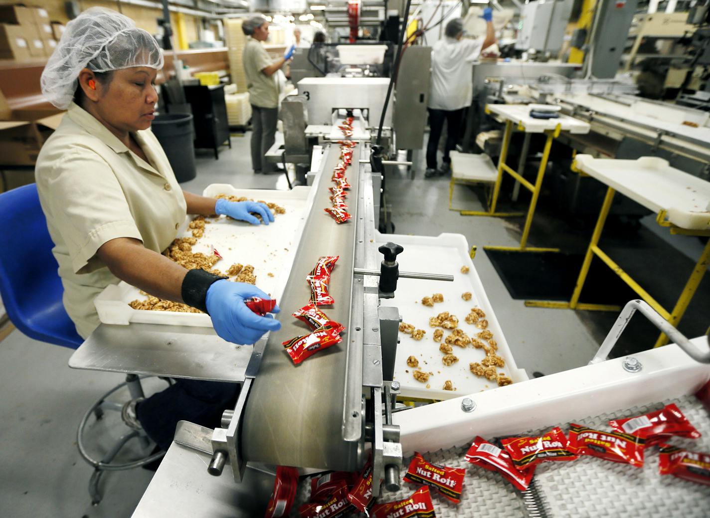 Khom Phun sorted bite-size Salted Nut Rolls coming off the line at Pearson Candy Co. in St. Paul.