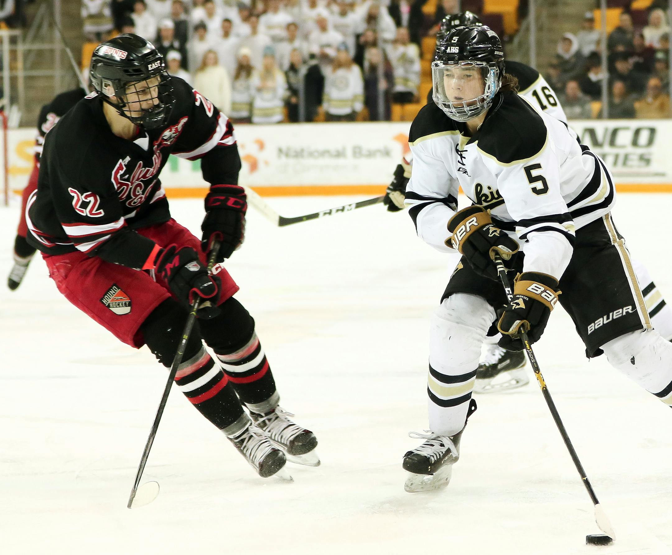 Andover's Wyatt Kaiser takes the puck to the net around Duluth East's Ryder Donovan during Thursday night's Section 7AA championship game at Amsoil Arena. Dave Harwig, SportsEngine