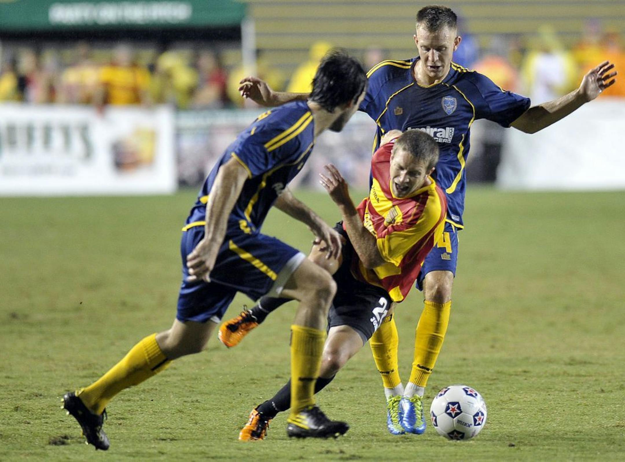 Fort Lauderdale Strikers Brian Shriver tries to control the ball between Minnesota Stars defenders Cristiano Dias and Neil Hlavaty during the first half in the NASL Championship Series Finals on Saturday.