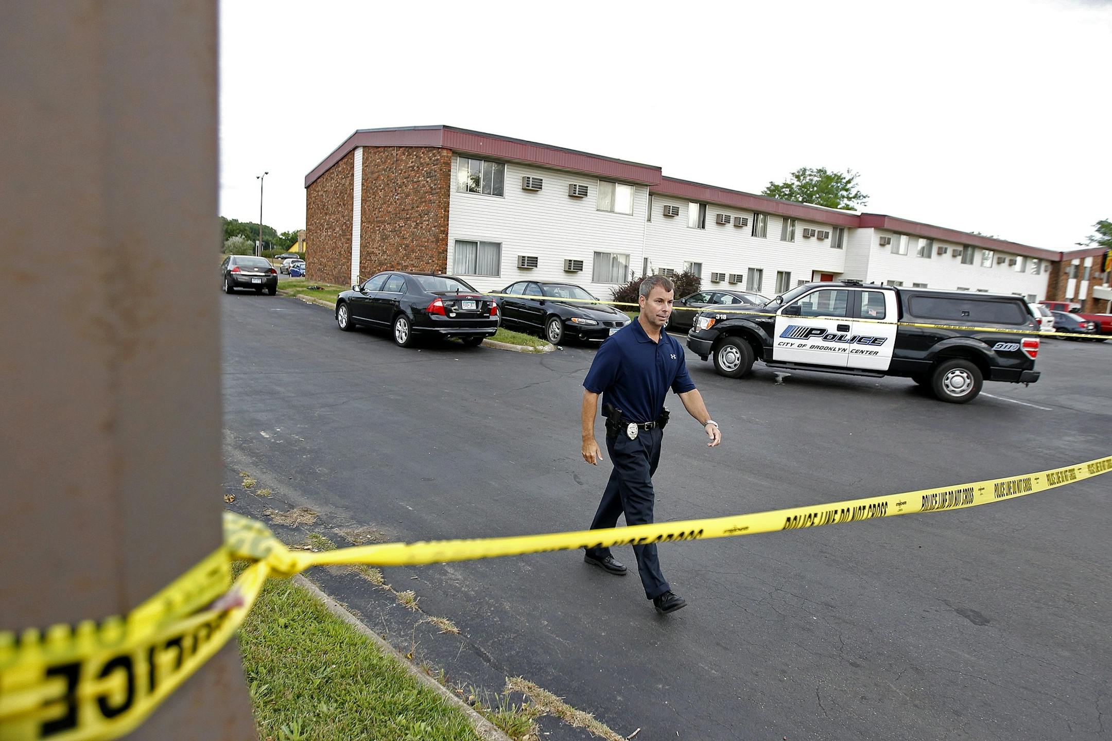Brooklyn Center Police Commander Tim Gannon made his way around a crime scene that spanned a Denny's Restaurant, Days Inn & Suites Hotel, and a Super 8, early Thursday, August 22, 2013 in Brooklyn Center.
