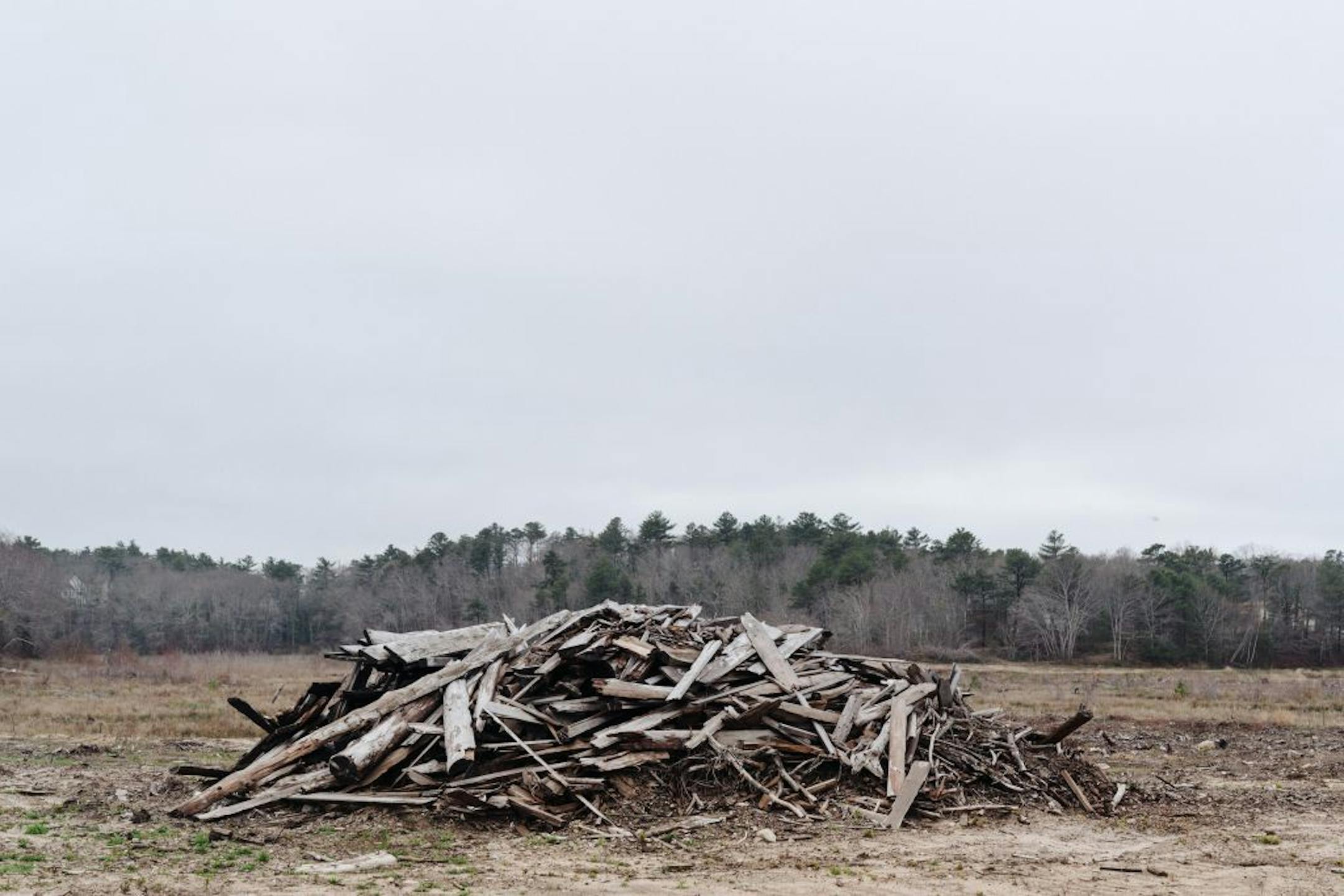 A pile of leftover wood from transformation efforts at a former cranberry bog at Mass Audubon's Tidmarsh Wildlife Sanctuary in Plymouth, Mass., April 27, 2017. Scientists are turning a cranberry bog back into coastal wetland. The experiment is seen as a path for dormant bogs and another chance for vanishing habitat.