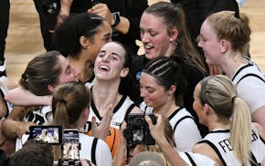 Iowa guard Caitlin Clark, center, celebrates with teammates after Iowa defeated LSU for a trip to the Final Four.
