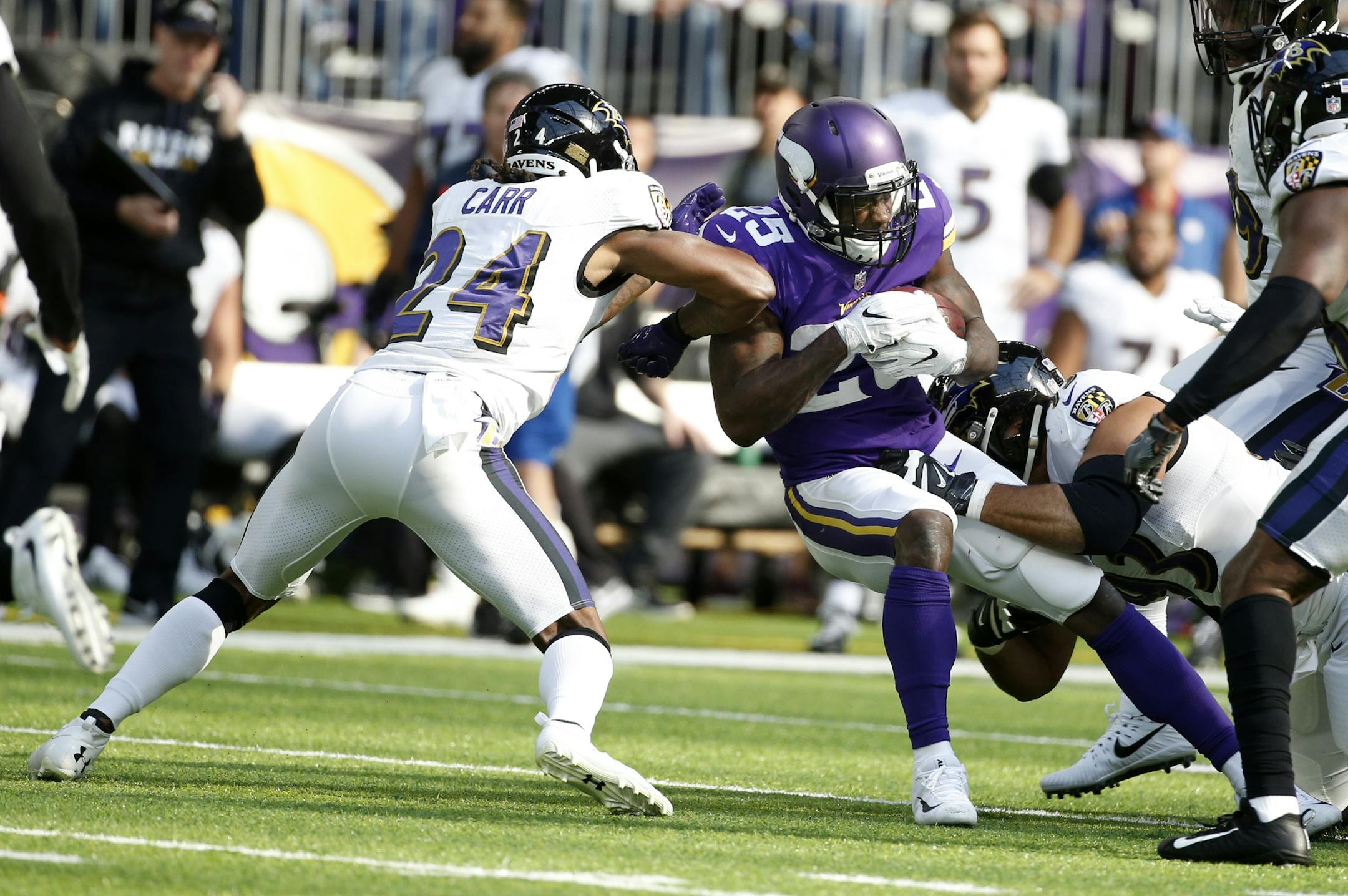 Minnesota Vikings running back Latavius Murray (25) runs from Baltimore Ravens cornerback Brandon Carr, left, during the first half of an NFL football game, Sunday, Oct. 22, 2017, in Minneapolis. (AP Photo/Bruce Kluckhohn)