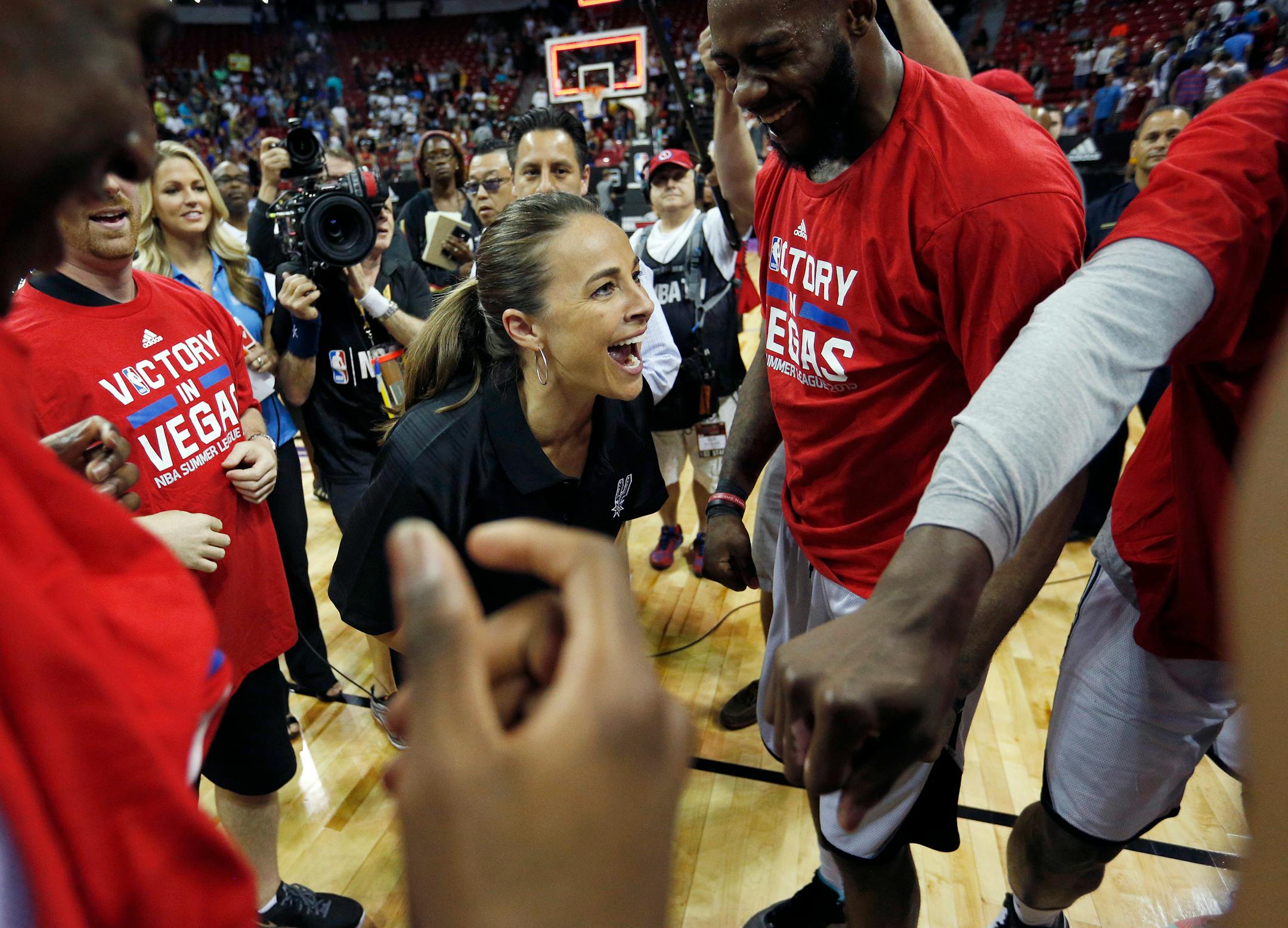 San Antonio Spurs Summer League coach Becky Hammon celebrated with her team after it defeated the Phoenix Suns in an NBA Summer League championship game. Hammon is an assistant coach for the Spurs during the regular season.