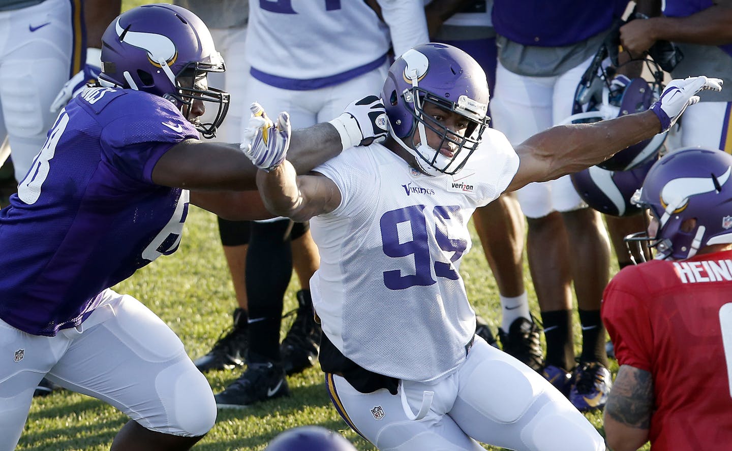 Danielle Hunter (99) attempted to get around T.J. Clemmings (68) during an evening practice.