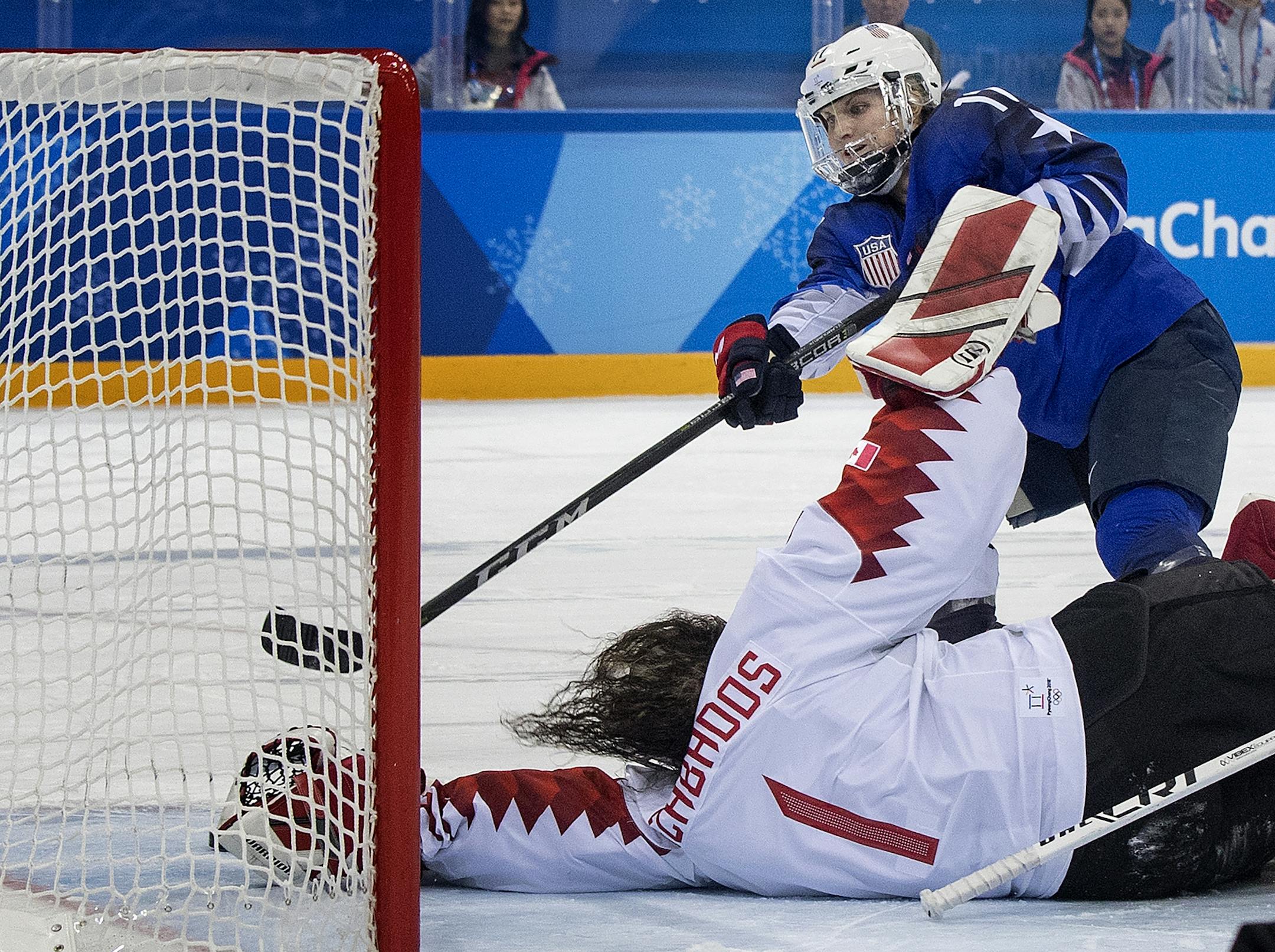Jocelyne Lamoureux-Morando (17) shot the puck past Canada goalie Shannon Szabados (1) during the shootout.