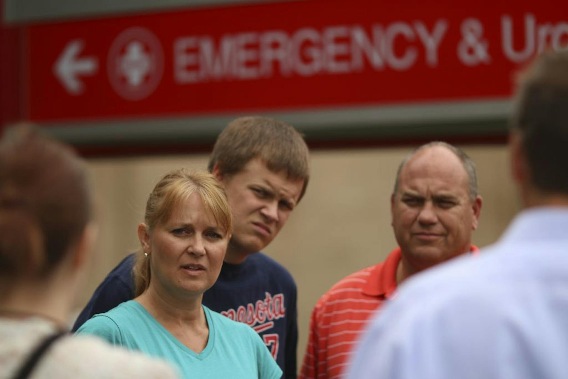 The family of Luke Nelson, the Dassel-Cokato High School middle linebacker who suffered a head injury in a football game Friday night, spoke to members of the news media about their son outside Hennepin County Medical Center Sunday afternoon, September 8, 2013. Luke's mother, Sara, brother, Isaac, and father, Greg, from left, talked about his injury, which doctors treated by removing a portion of his skull to relieve pressure from the injury.