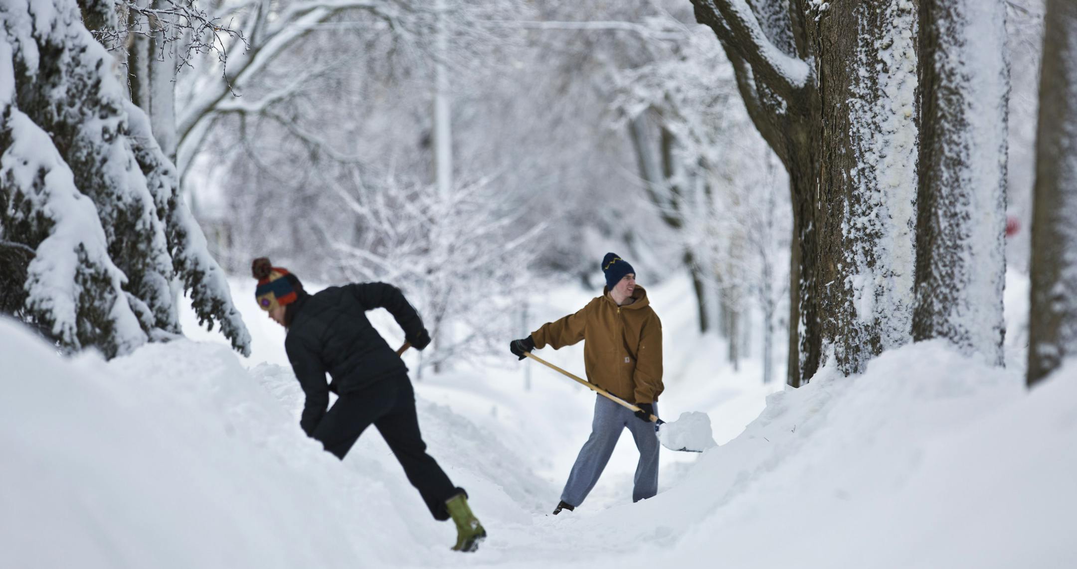 Neighbors Andrea Page and Peter Jorgensen were two of several neighbors clearing the sidewalk of their Minneapolis neighborhood which had still yet to be plowed the morning after 10.5 inches of snow fell in the Minneapolis, Minn., on Friday, February 22, 2014. ] (RENEE JONES SCHNEIDER reneejones@startribune.com) ORG XMIT: MIN1402211137444154