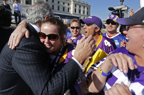 In front of the State Capitol, Vikings owner Zygi Wilf hugged a fan as he arrived for the announcement the passing of a Vikings stadium bill.