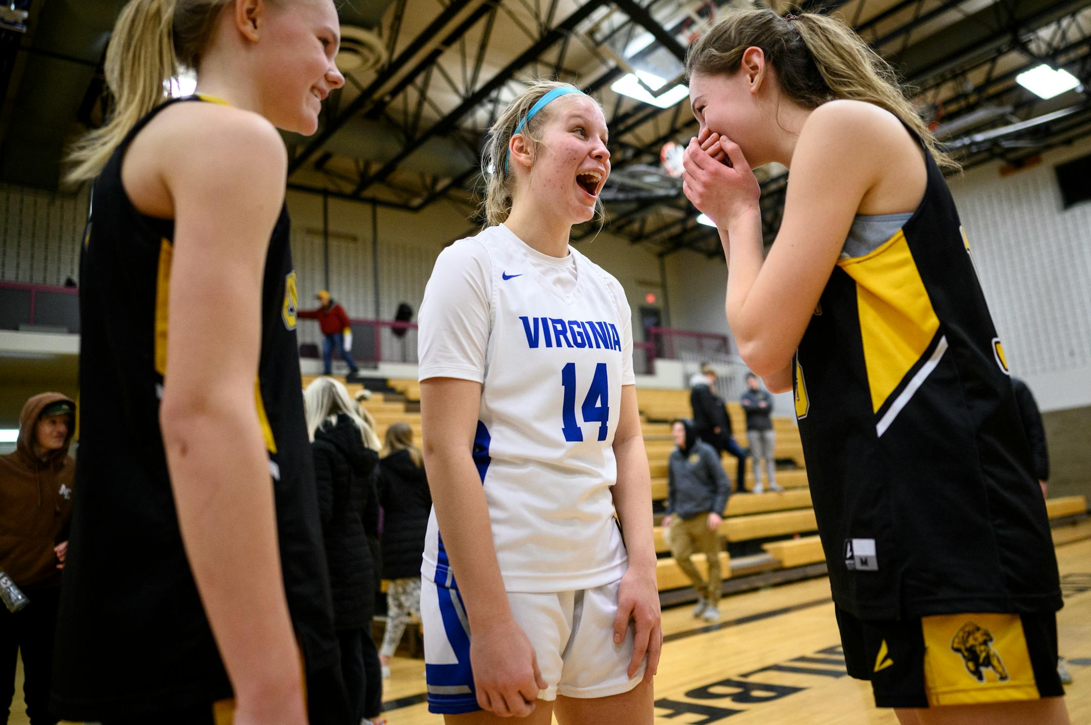 Virginia's Macy Westby, center, laughs with her cousins Anna, left, and Joey after their basketball game against each other Monday, Feb. 21, 2022. Anna and Macy will be playing with each other on the same team next year after their teams consolidate under the new Rock Ridge district. Joey is a graduating senior.