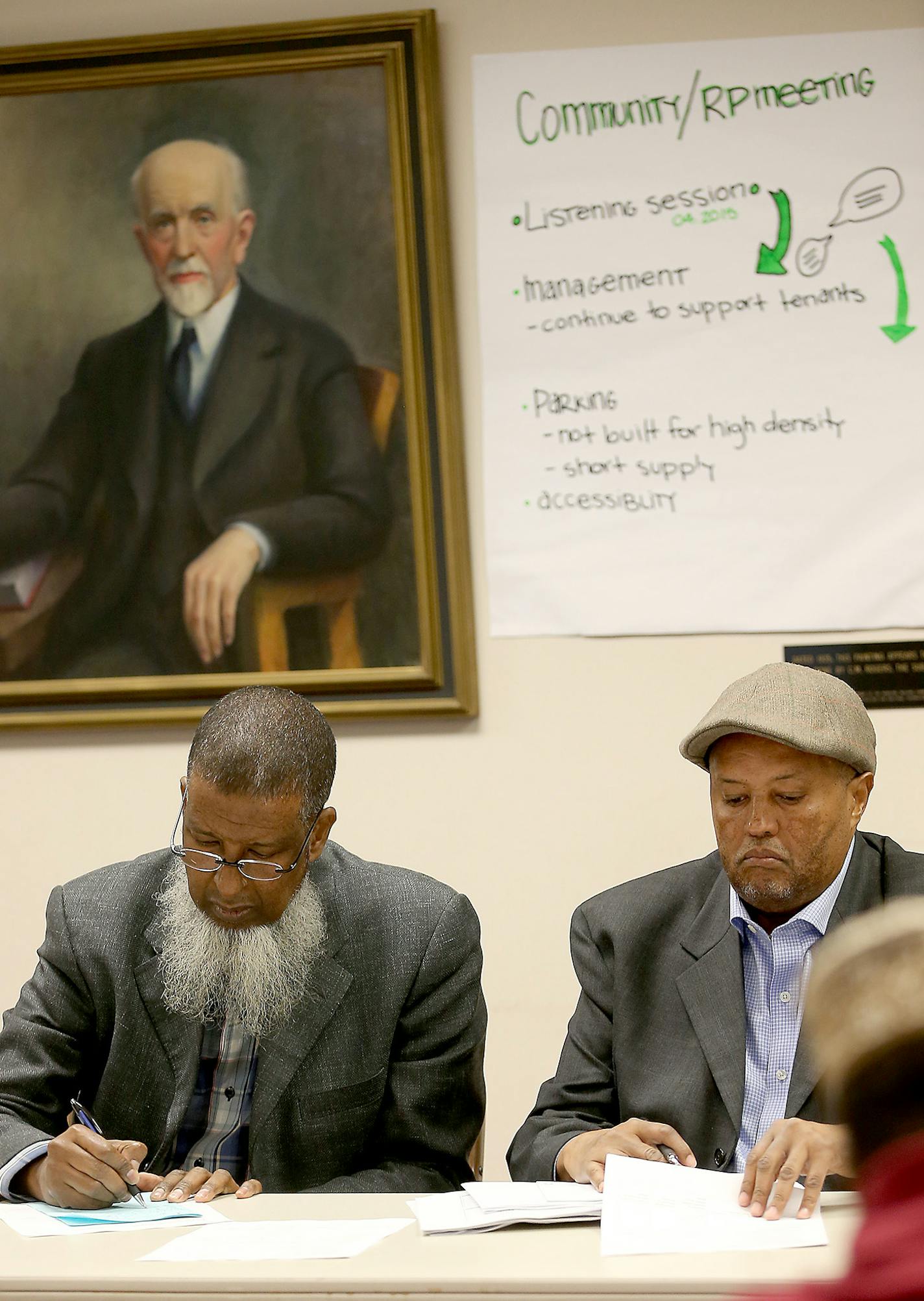 Riverside Plaza Tower residents read over an agreement brought before them by building owner George Sherman and Council Member Abdi Warsame regarding several issues causing turmoil, Monday, May 11, 2015 at City Hall in Minneapolis, MN. ] (ELIZABETH FLORES/STAR TRIBUNE) ELIZABETH FLORES &#x2022; eflores@startribune.com