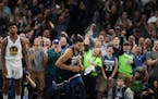 Minnesota Timberwolves center Karl-Anthony Towns (32) celebrated as Golden State Warriors guard Nick Young (6) looked on late in the 4th period at Tar
