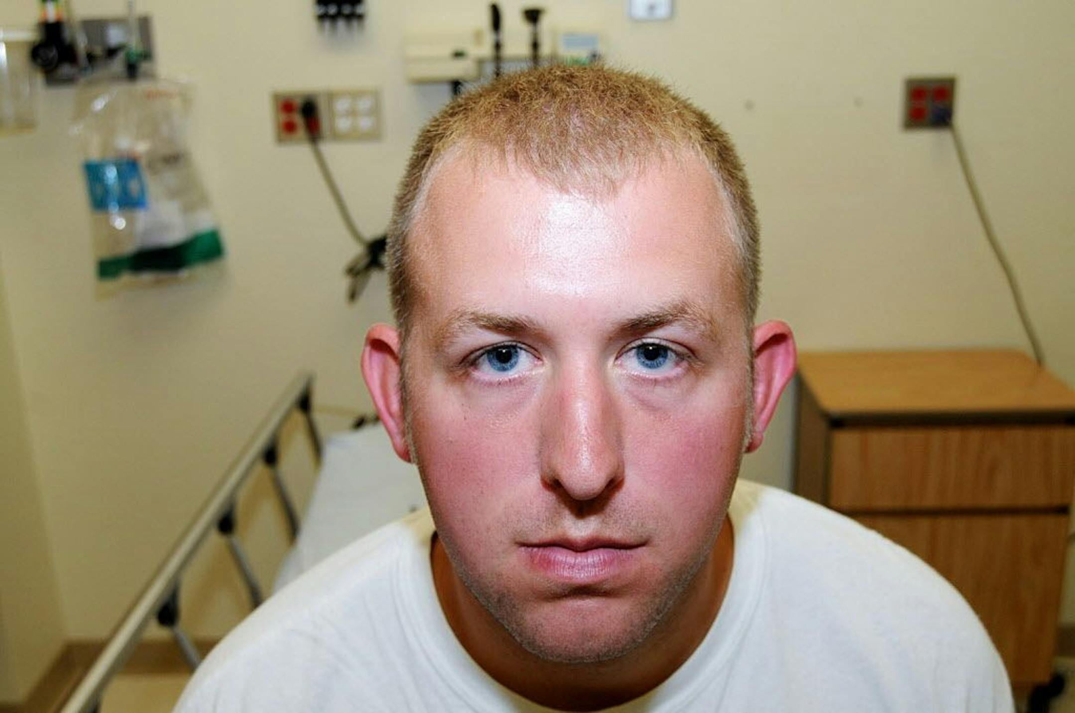This undated photo released by the St. Louis County Prosecuting Attorney's office on Monday, Nov. 24, 2014, shows Ferguson police officer Darren Wilson during his medical examination after he fatally shot Michael Brown,�in Ferguson, Mo.