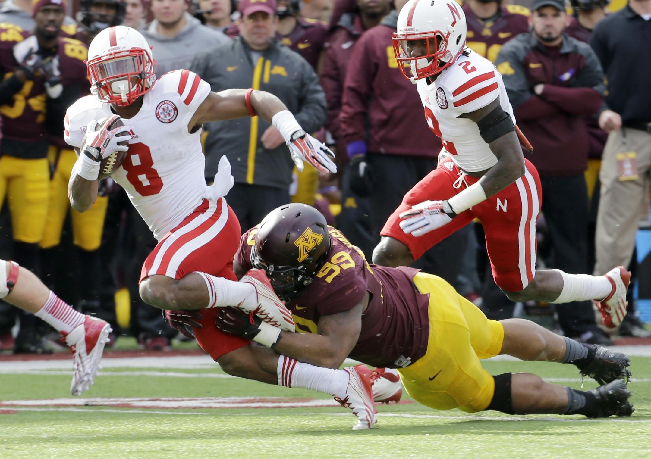 Minnesota defensive lineman Ra'Shede Hageman (99) tackles Nebraska running back Ameer Abdullah (8) on a 6-yard gain during the second quarter of an NCAA college football game in Minneapolis Saturday, Oct. 26, 2013. Minnesota beat Nebraska 34-23. (AP Photo/Ann Heisenfelt)
