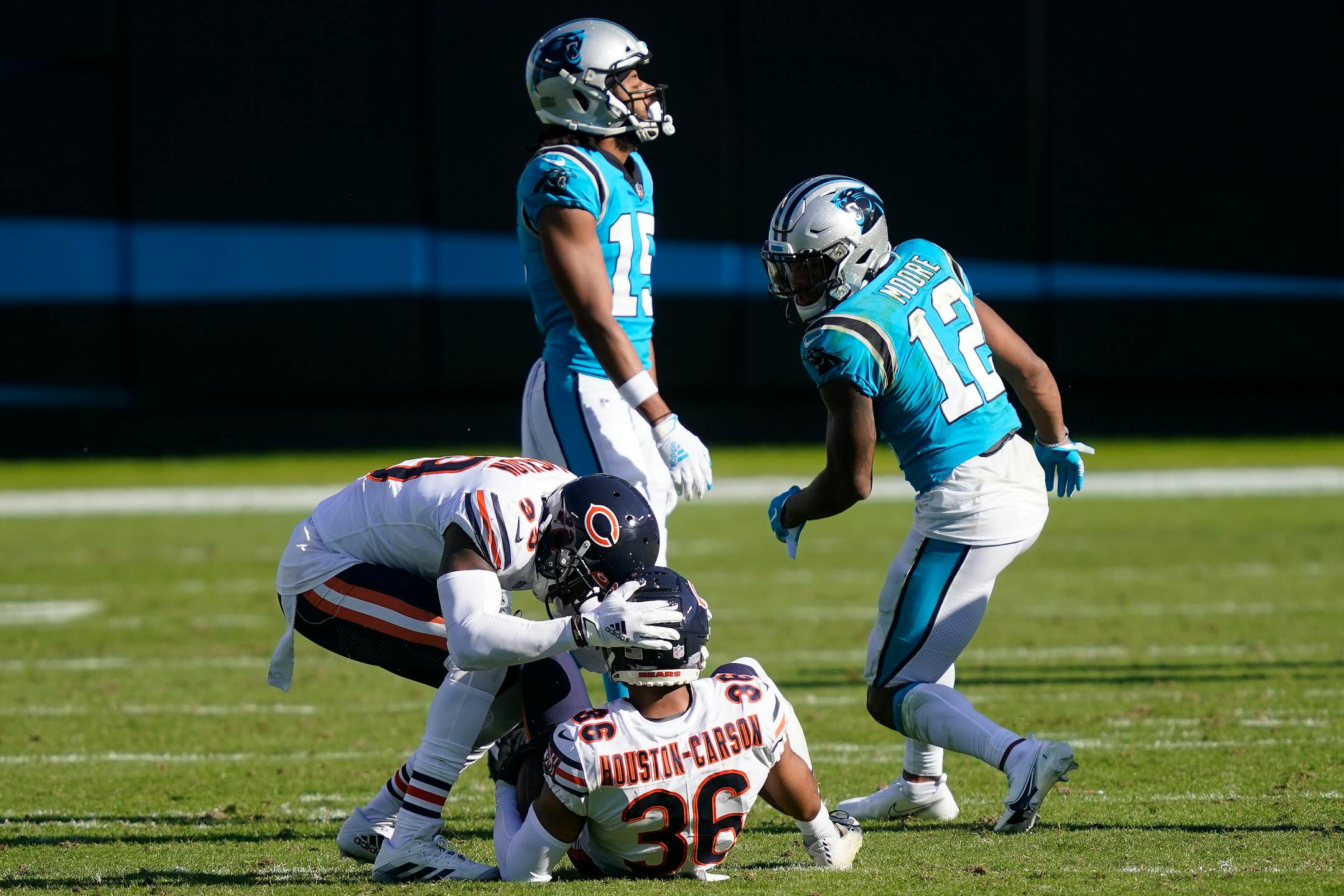 Bears free safety Eddie Jackson (left) congratulated defensive back DeAndre Houston-Carson following Carson's interception in front of Panthers wide receiver D.J. Moore (12) on Sunday.