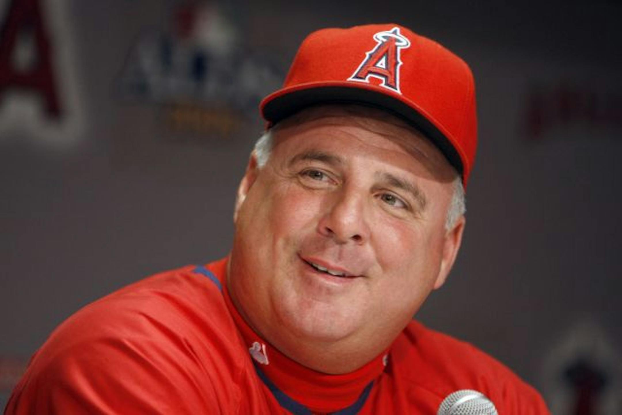 In this Sept. 30, 2008, file photo, Los Angeles Angels manager Mike Scioscia smiles during a news conference for baseball's AL division series in Anaheim, Calif. Scioscia's extension with the Angels puts the most successful manager in franchise history under contract through the 2018 season. Two people with knowledge of the negotiations told The Associated Press the parties agreed to a 10-year deal that allows Scioscia to opt out after the 2015 season.