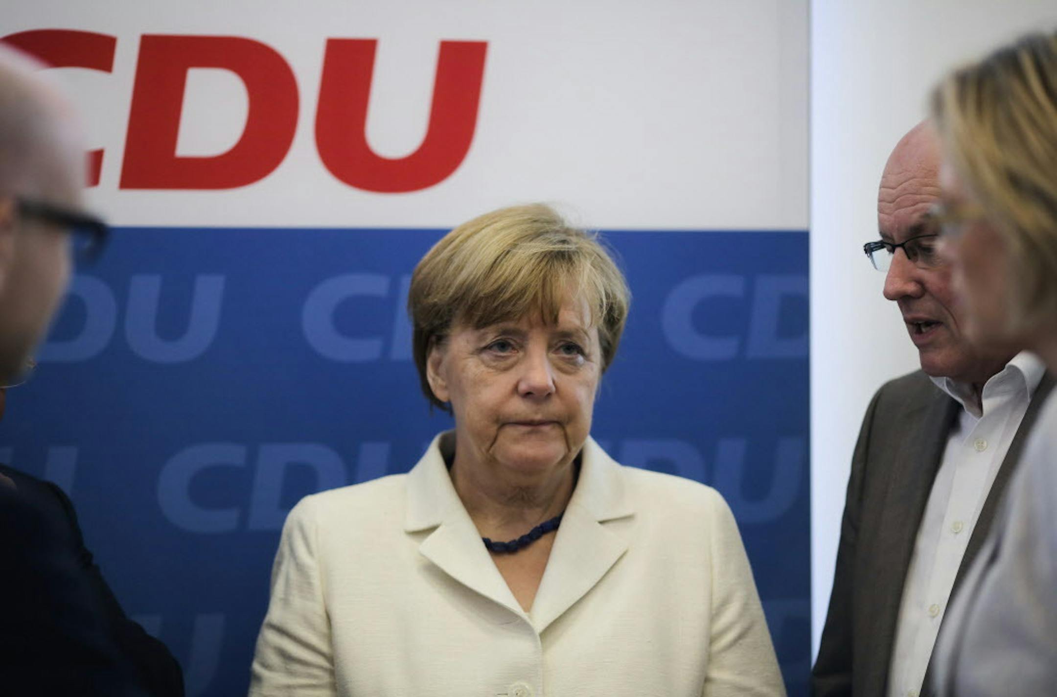 German Chancellor Angela Merkel, center, attends a leaders meeting of her Christian Democratic Union, CDU party at the party's headquarters in Berlin, Germany, Monday, July 13, 2015. A summit of eurozone leaders reached a tentative agreement with Greece on Monday for a bailout program that includes "serious reforms" and aid, removing an immediate threat that Greece could collapse financially and leave the euro. (AP Photo/Markus Schreiber)