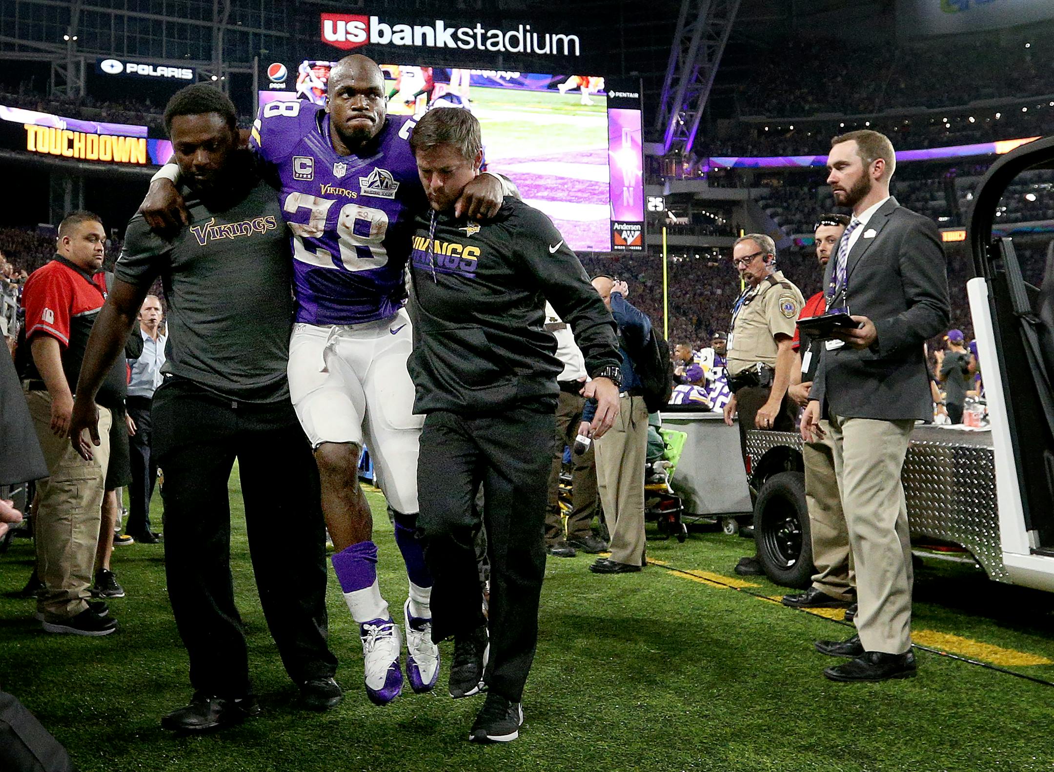 Minnesota Vikings running back Adrian Peterson (28) was helped back to the locker room in the third quarter after leaving the game. ] CARLOS GONZALEZ cgonzalez@startribune.com - September 18, 2016, Minneapolis, MN, US Bank Stadium, NFL, Minnesota Vikings vs. Green Bay Packers