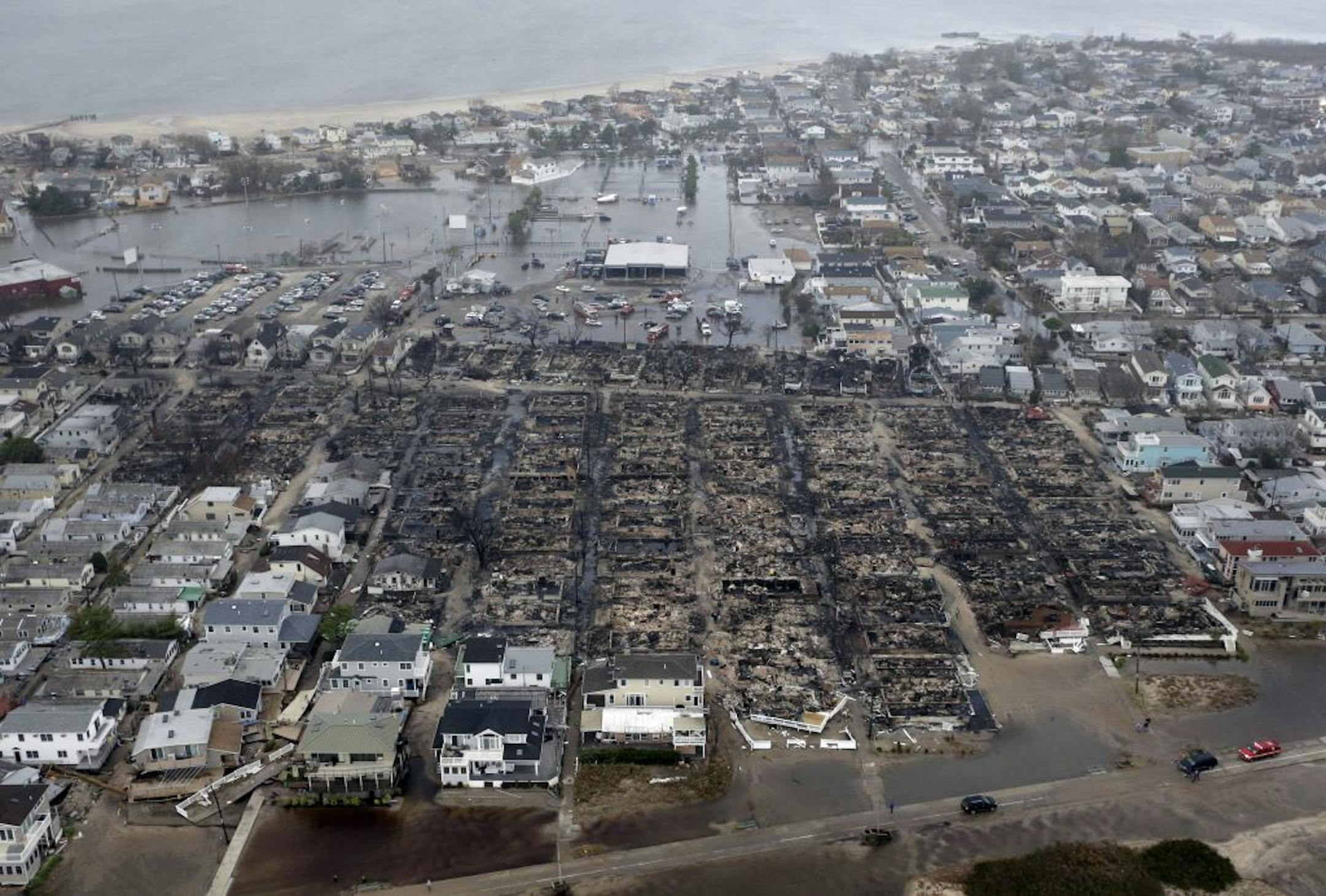 This aerial photo shows burned-out homes and flooding in the Breezy Point section of the Queens borough New York after a fire during Superstorm Sandy.
