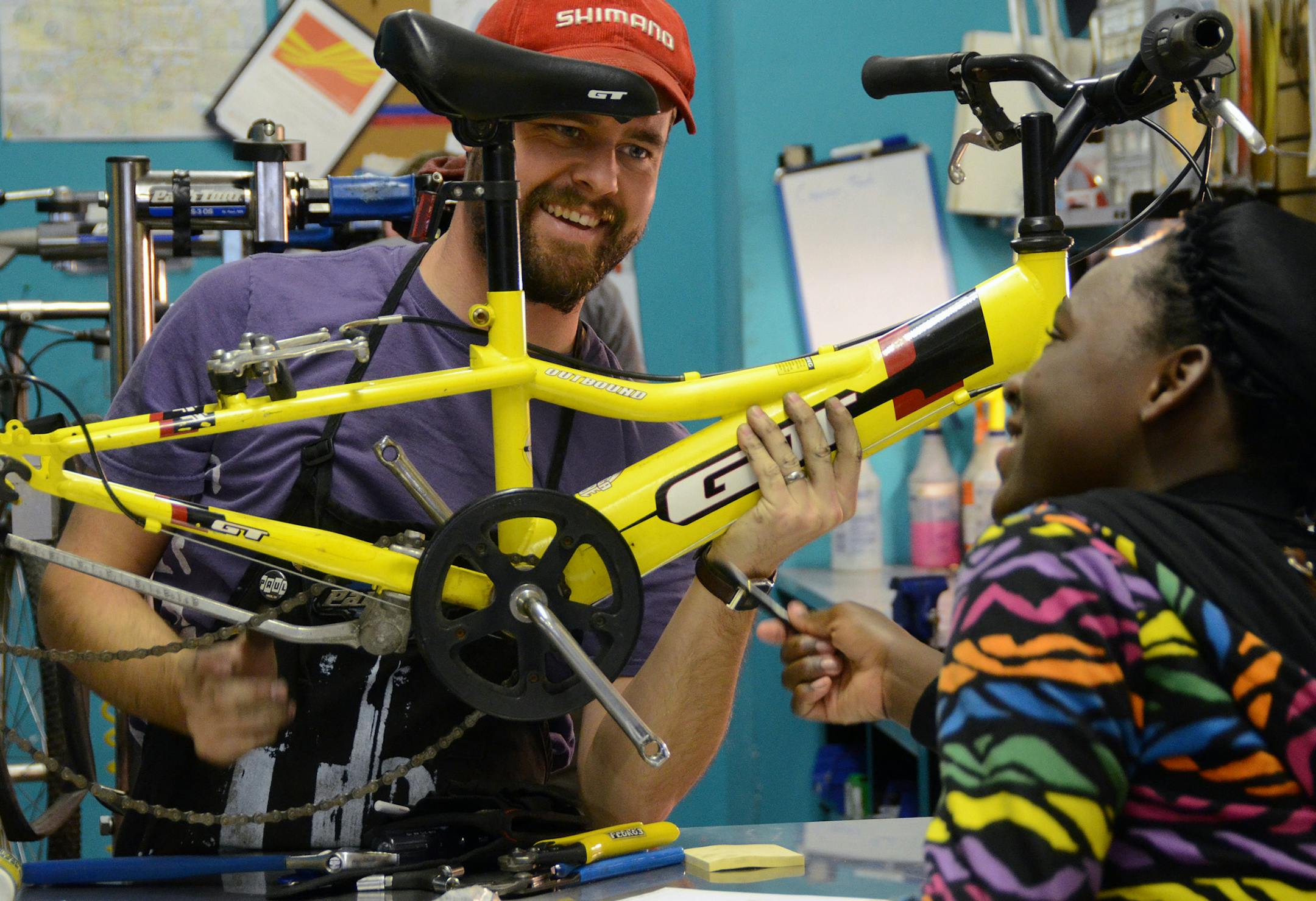 (Left to right) Casey Pavek, manager of Venture North Bike Walk & Coffee, taught bike repair to 13-year-old Kieara Sampson during Open Shop when the bike shop becomes a classroom for the community. Sampson will earn a free bike by learning how to fix it. ]Joey McLeister,Special to the Star Tribune,St. Paul,MN October15,2013