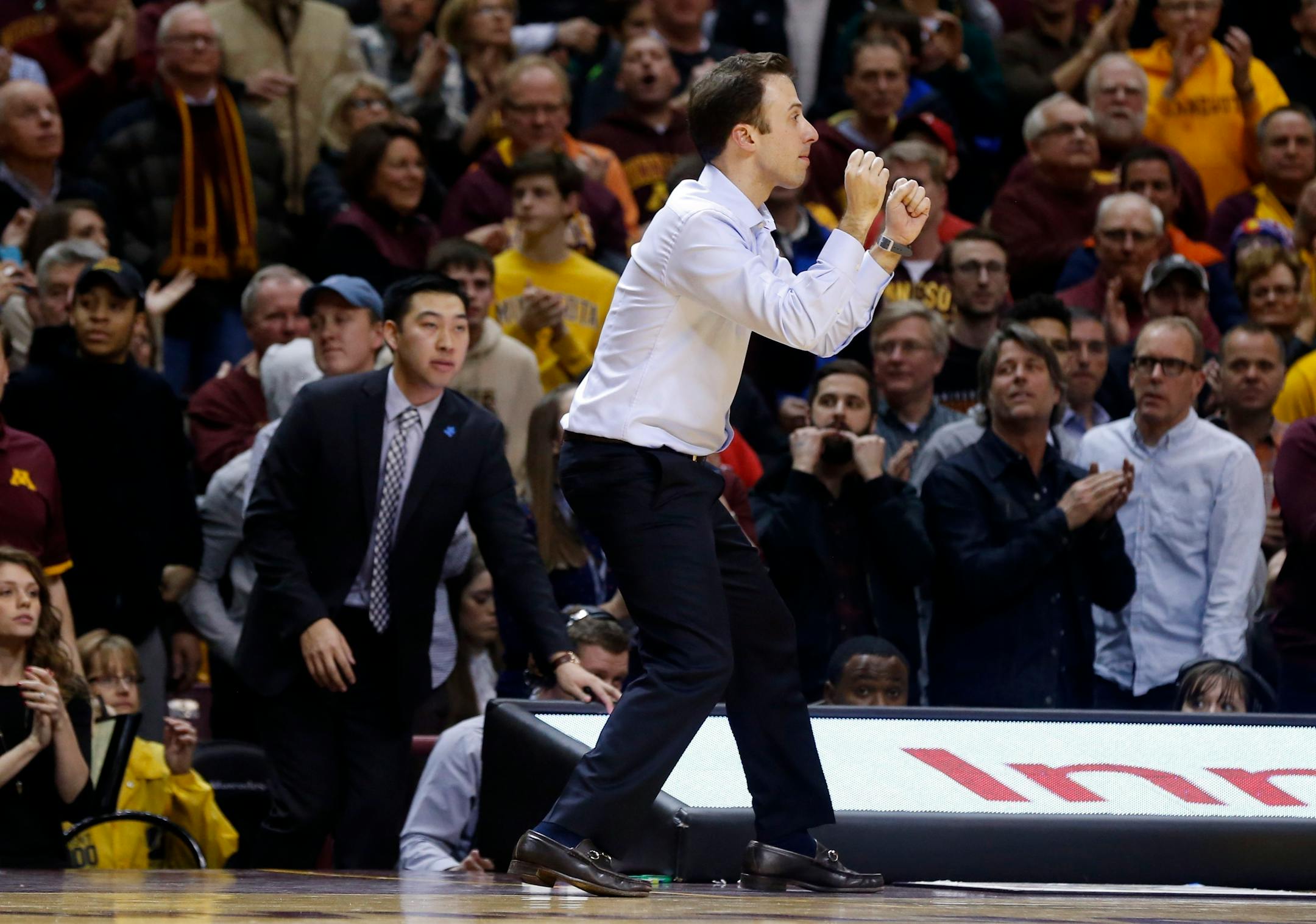 Minnesota head coach Richard Pitino celebrates in the final seconds as his team beat Maryland 68-63 in an NCAA college basketball game Thursday, Feb. 18, 2016, in Minneapolis. (AP Photo/Jim Mone)