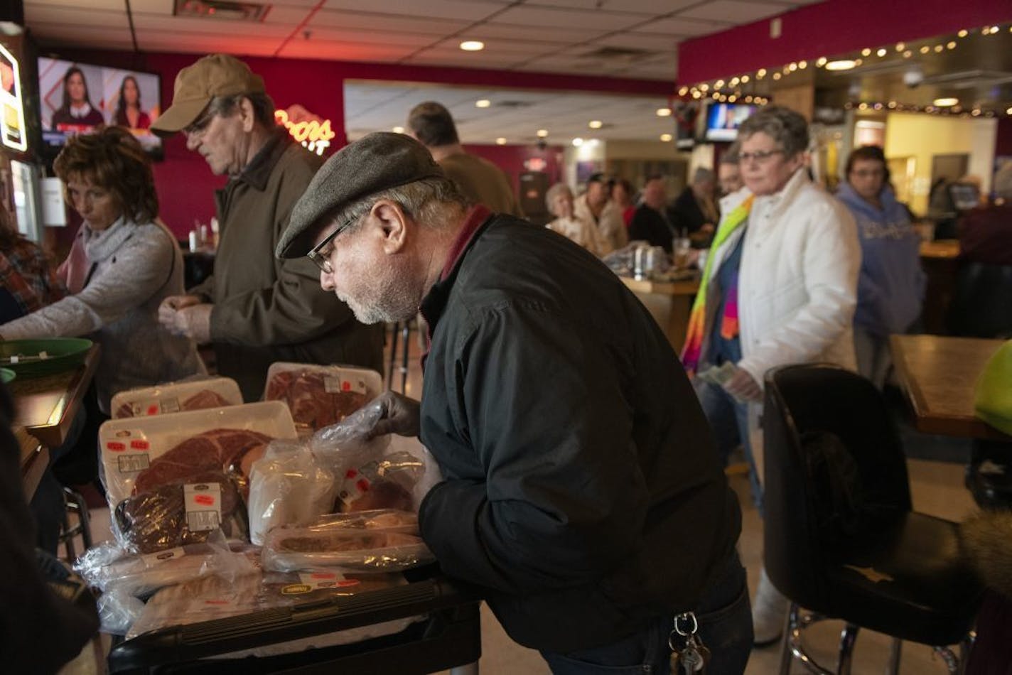 Scott Sadler looked at what meat he wanted to take home after winning a raffle.