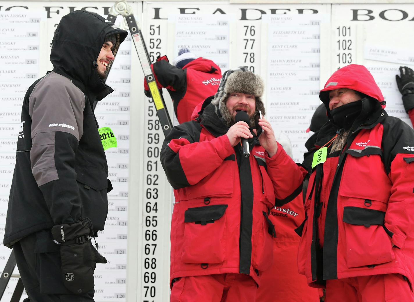 Stephen Lyogky (left) and his father Ivan Lyogky (right) from Hartville, Ohio, talking with radio host Brian Moon of B93.3. The Lyogkys took first and third place respectively with a 3.10 pound northern pike and 2.51 pound northern pike Saturday at the Jaycees Ice-fishing Extravaganza on Gull Lake. Kelly Humphrey Brainerd Dispatch