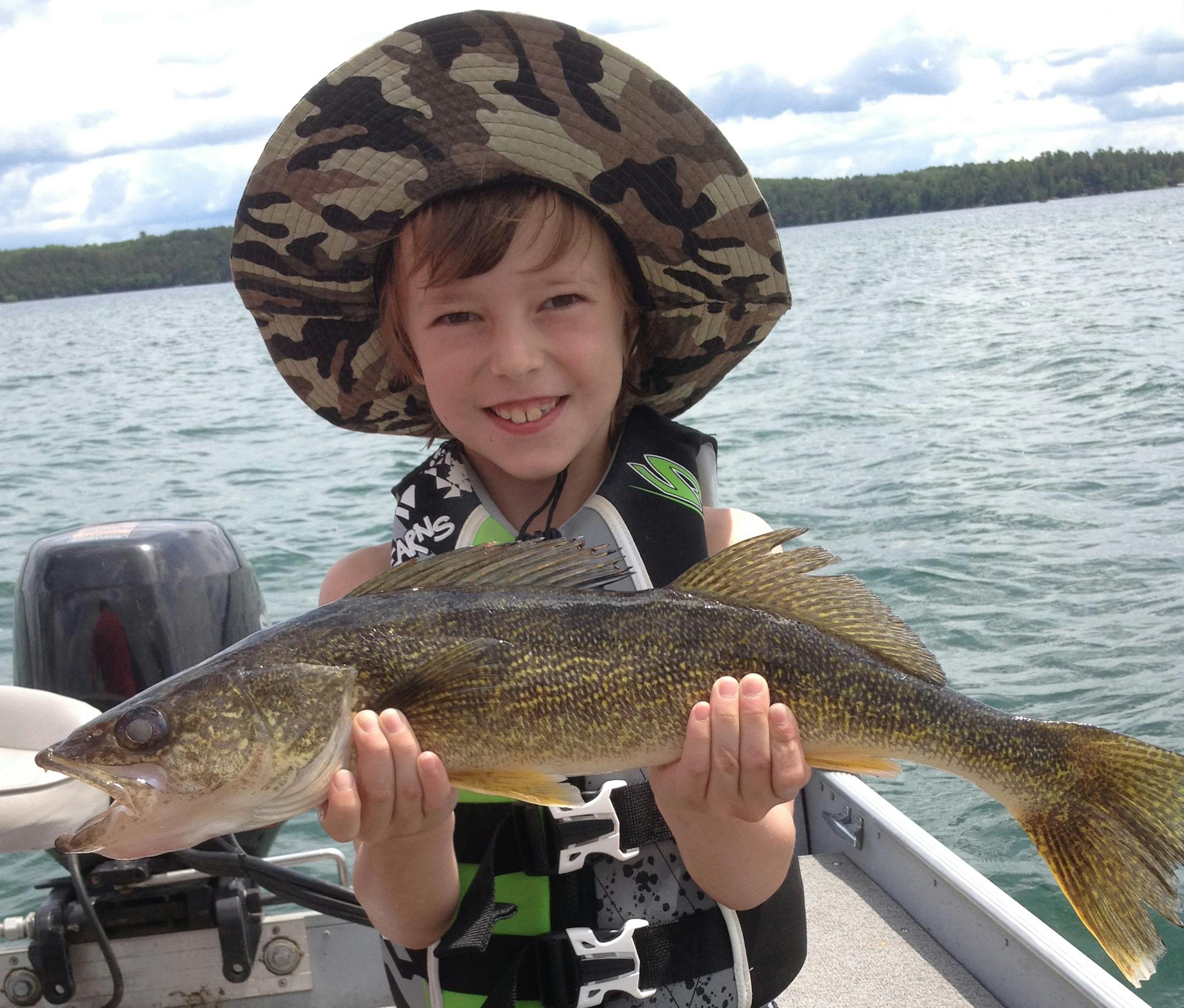 HOOKED! Riley Naughton, 7, of Minneapolis caught this 23-inch walleye while vacationing at Pine Cone Lodge on Big Sand Lake. She caught it on her first day on the lake, and spent the rest of the trip asking "When are we going fishing again?''