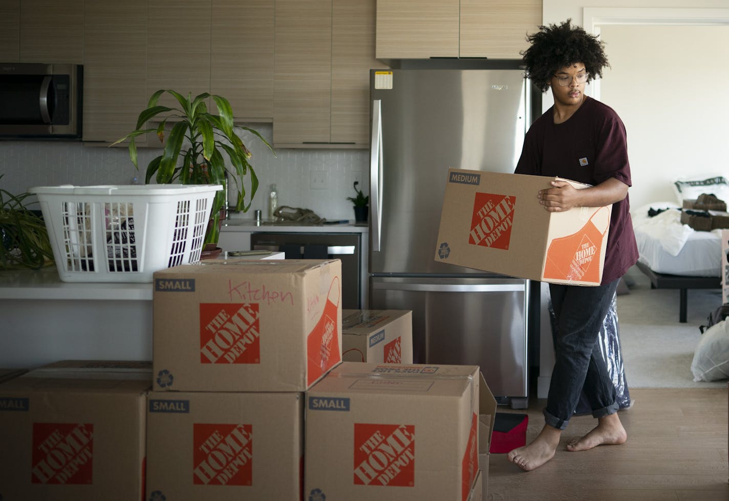 Nicholas Nicome helped his mother, Susan Cevette, move into the Rafter, a new apartment building in northeast Minneapolis.