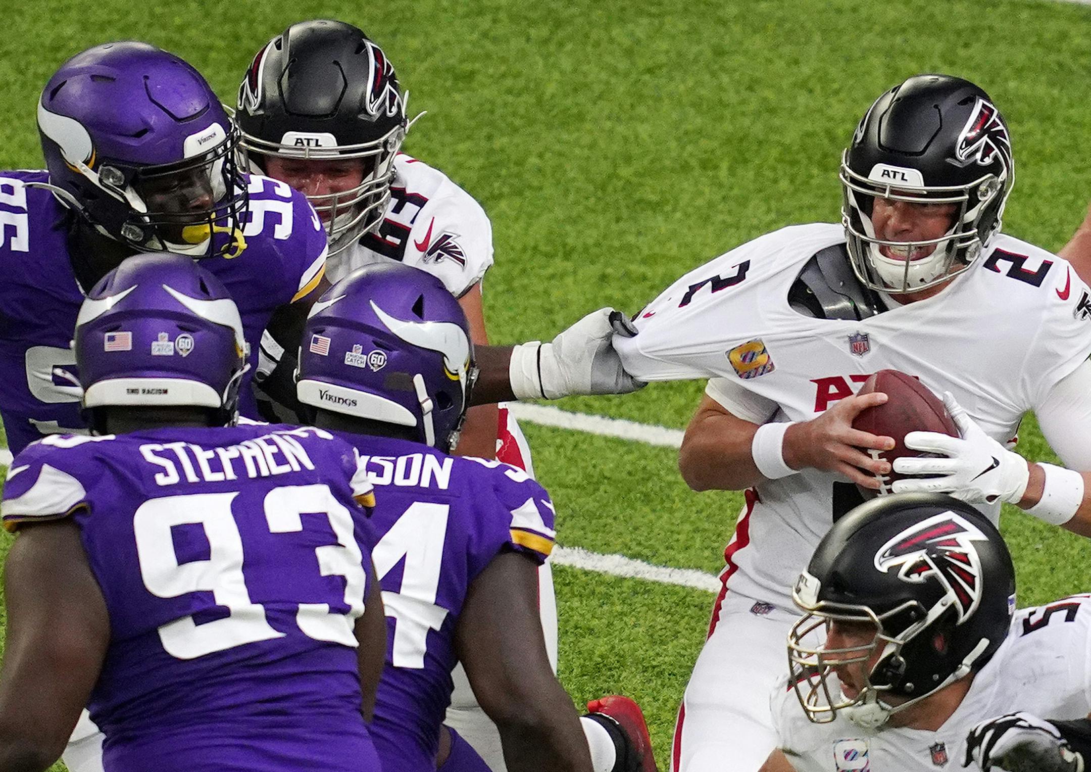 Minnesota Vikings defensive end Ifeadi Odenigbo (95) grabbed ahold of Atlanta Falcons quarterback Matt Ryan (2) as he scrambled in the pocket in the second quarter.