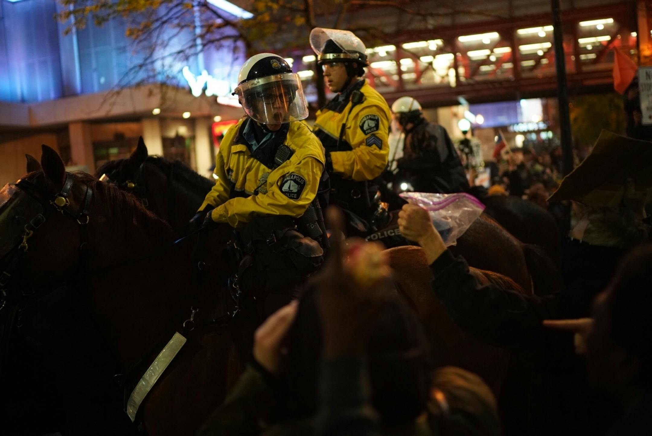 Mounted police officers moved through a crowd of demonstrators.