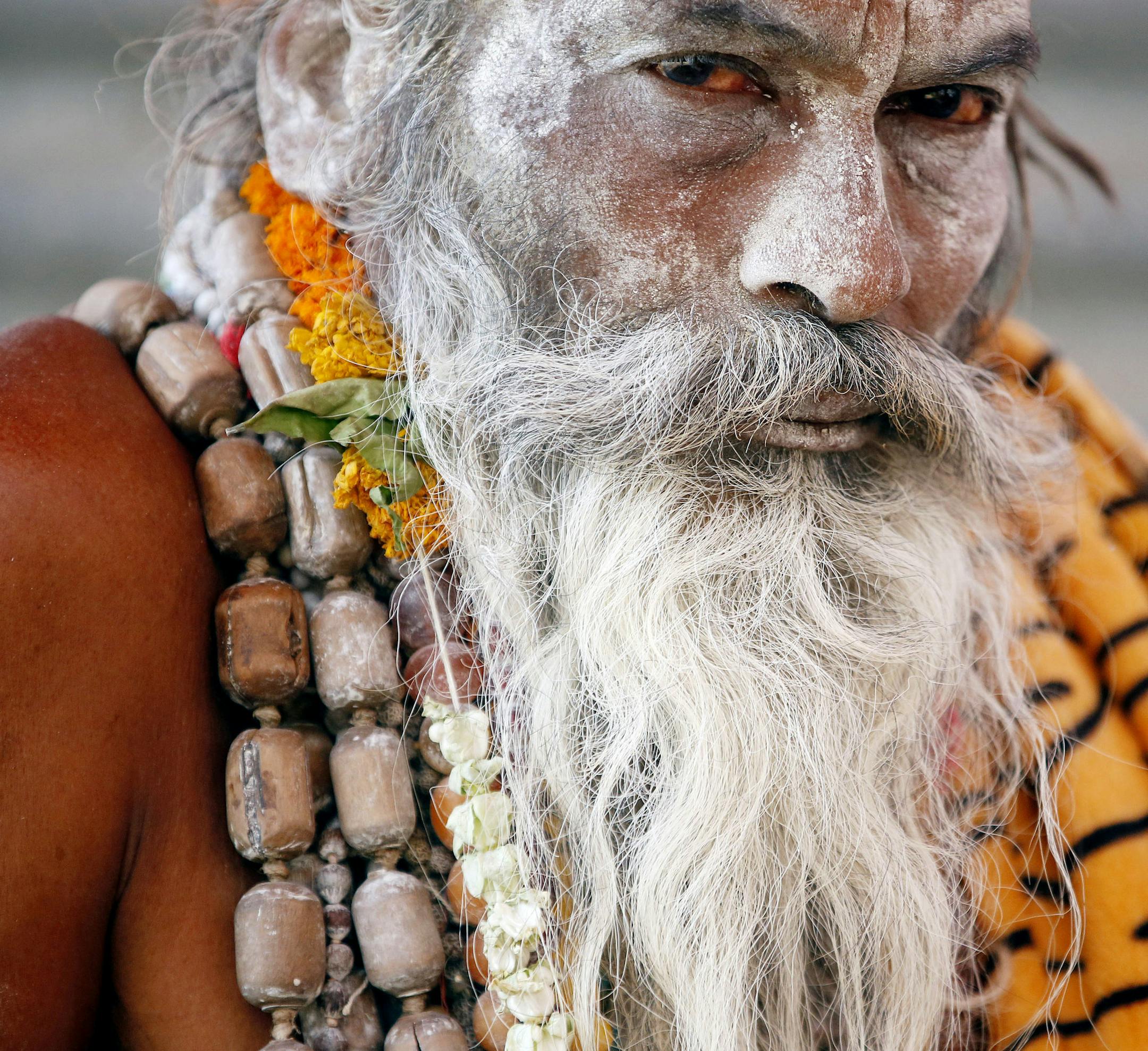 A Naga sadhu, or naked Hindu holy man sits inside his tent during the month long Kumbh festival at Ujjain in the central Indian state of Madhya Pradesh, Friday, May 13, 2016. Thousands of pilgrims have gathered in this holy city for the ritual dip in the River Shipra, which takes place once in 12 years. (AP Photo/Rajanish Kakade)