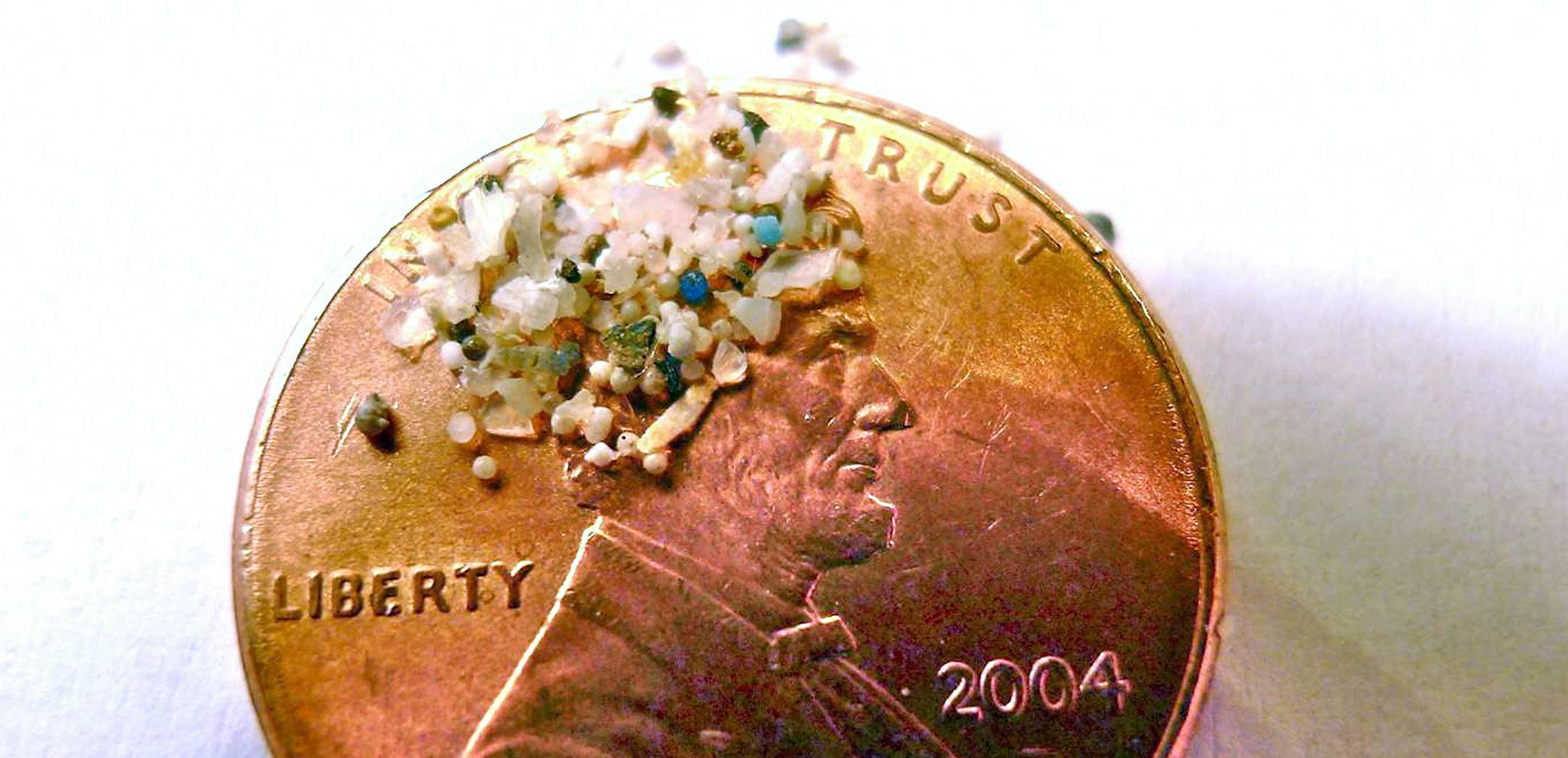 FILE - In this 2012 file photo provided by 5gyres.org, a sample of "microbeads" collected in eastern Lake Erie is shown on the face of a penny. Illinois environmentalists expecting a battle with business over a call for a ban on the tiny bits of plastic used in personal care products, found the industry quickly collaborated. With similar bans pending in at least three other large states, the extinction of microbeads, now showing up inside fish that are caught for human consumption, is happening