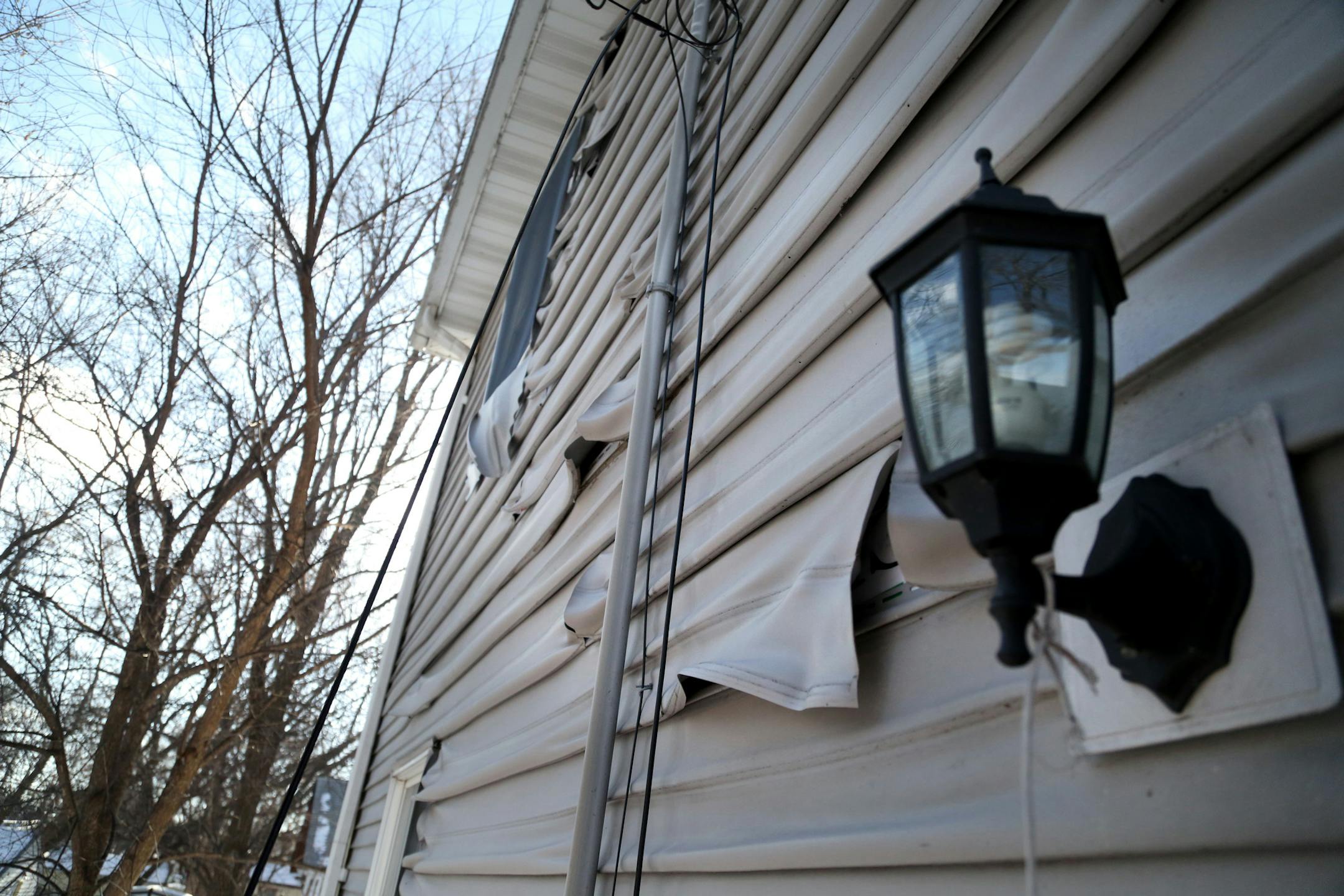 Tawanda Miller was swindled out of more than $7,000 by two men, possibly from Tennessee, posing as construction contractors who promised to build a garage at her north Minneapolis house. The garage had burned down earlier, possibly arson related. The siding on the east side of Miller's north side home was damaged from the heat coming from the garage fire and was seen Wednesday, Dec. 28, 2016, in Minneapolis, MN.] (DAVID JOLES STARTRIBUNE)djoles@startribune.com Tawanda Miller was swindled out of