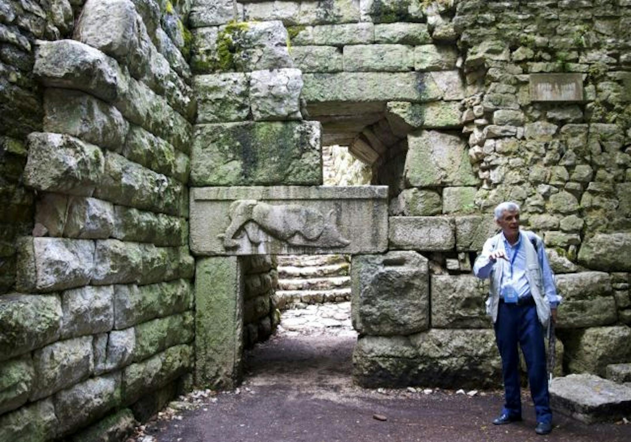 Tourguide Vangjel Xhani at the "Lion Gate," in Butrint, Albania. The relief shows a lion devouring a bull's head.