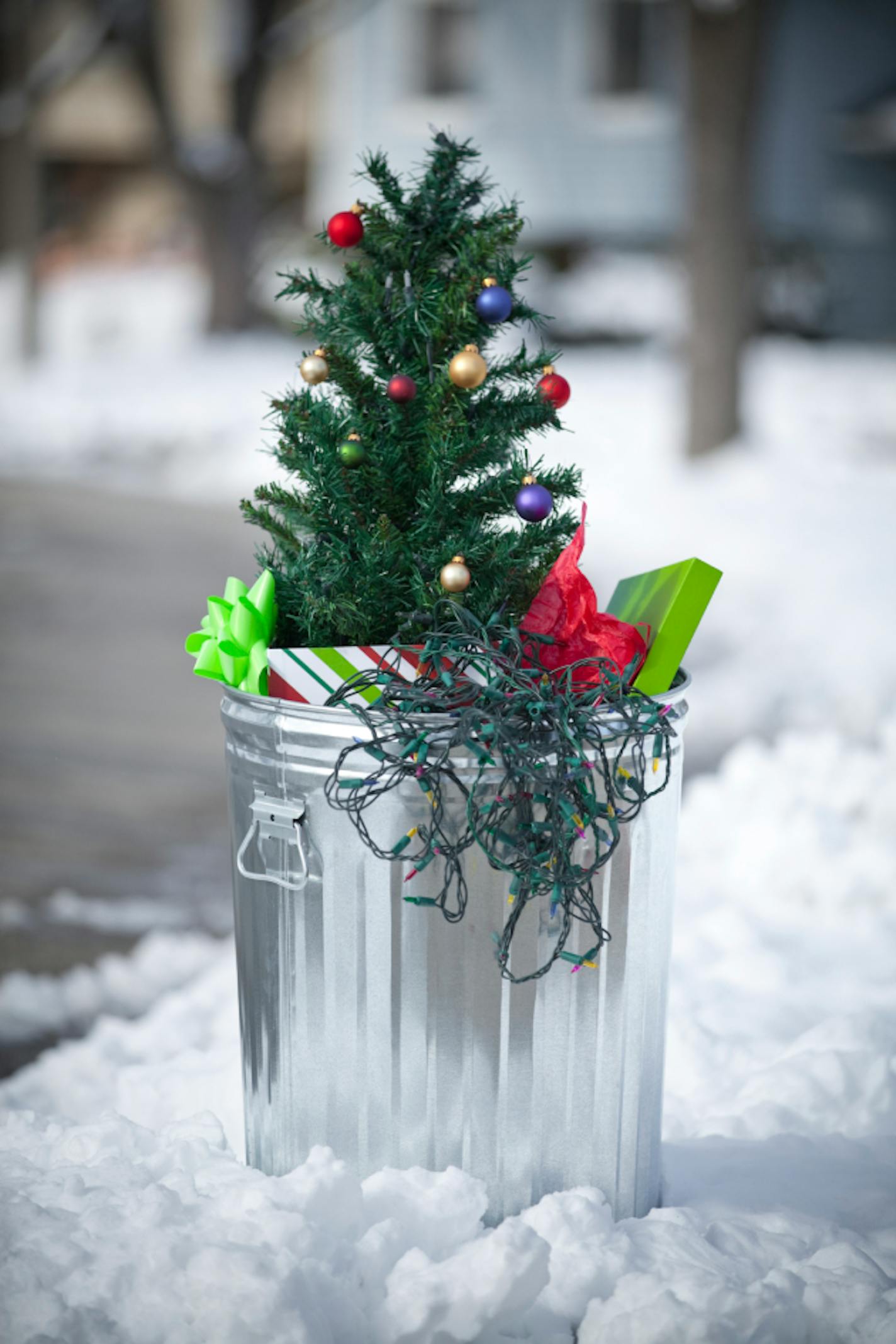 Christmas is over.  Xmas tree, gifts, wrapping paper and lights in the trash