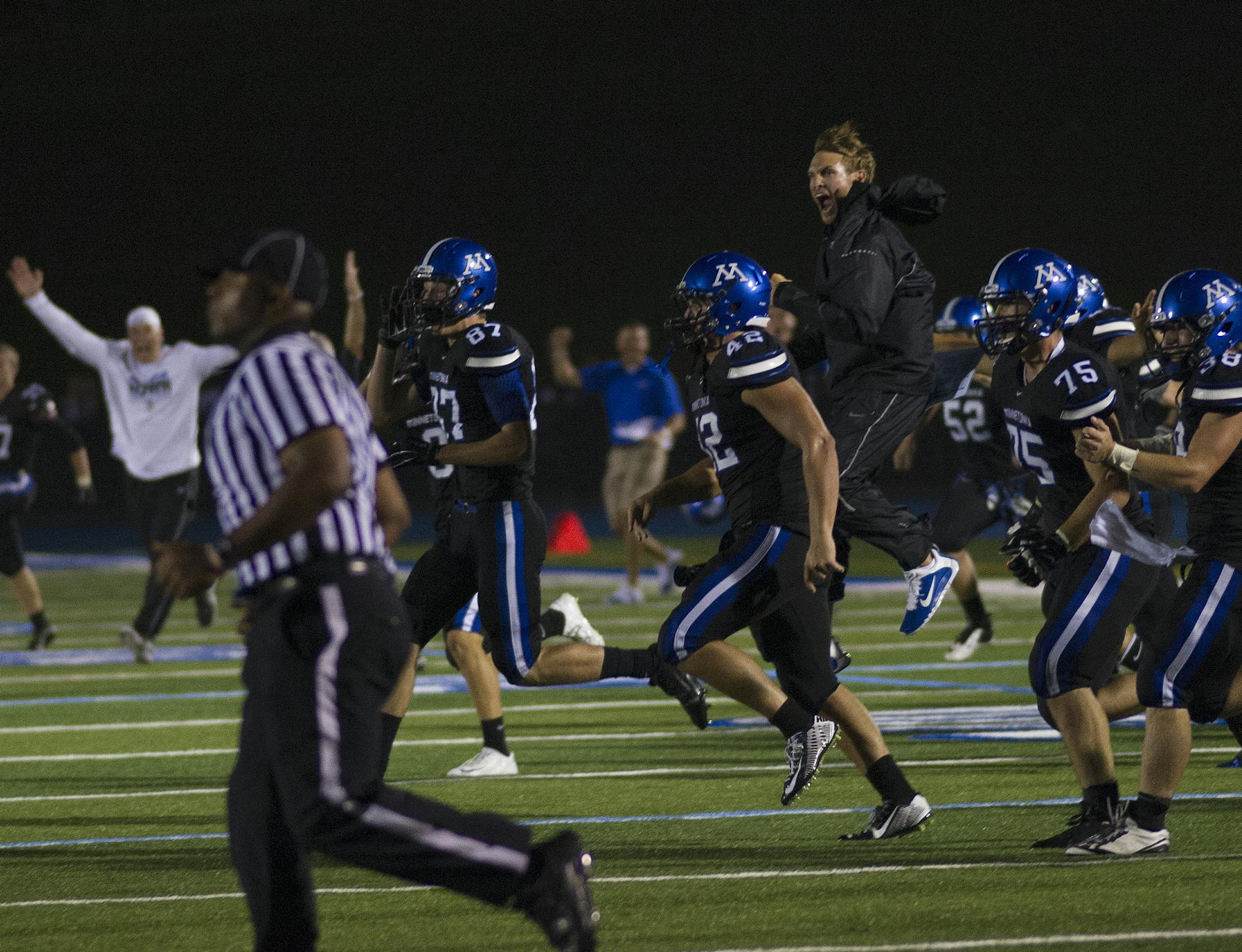Minnetonka rushes the field after winning Friday night's game against Becker 27-22. ] (Matthew Hintz, 083014, Minnetonka)