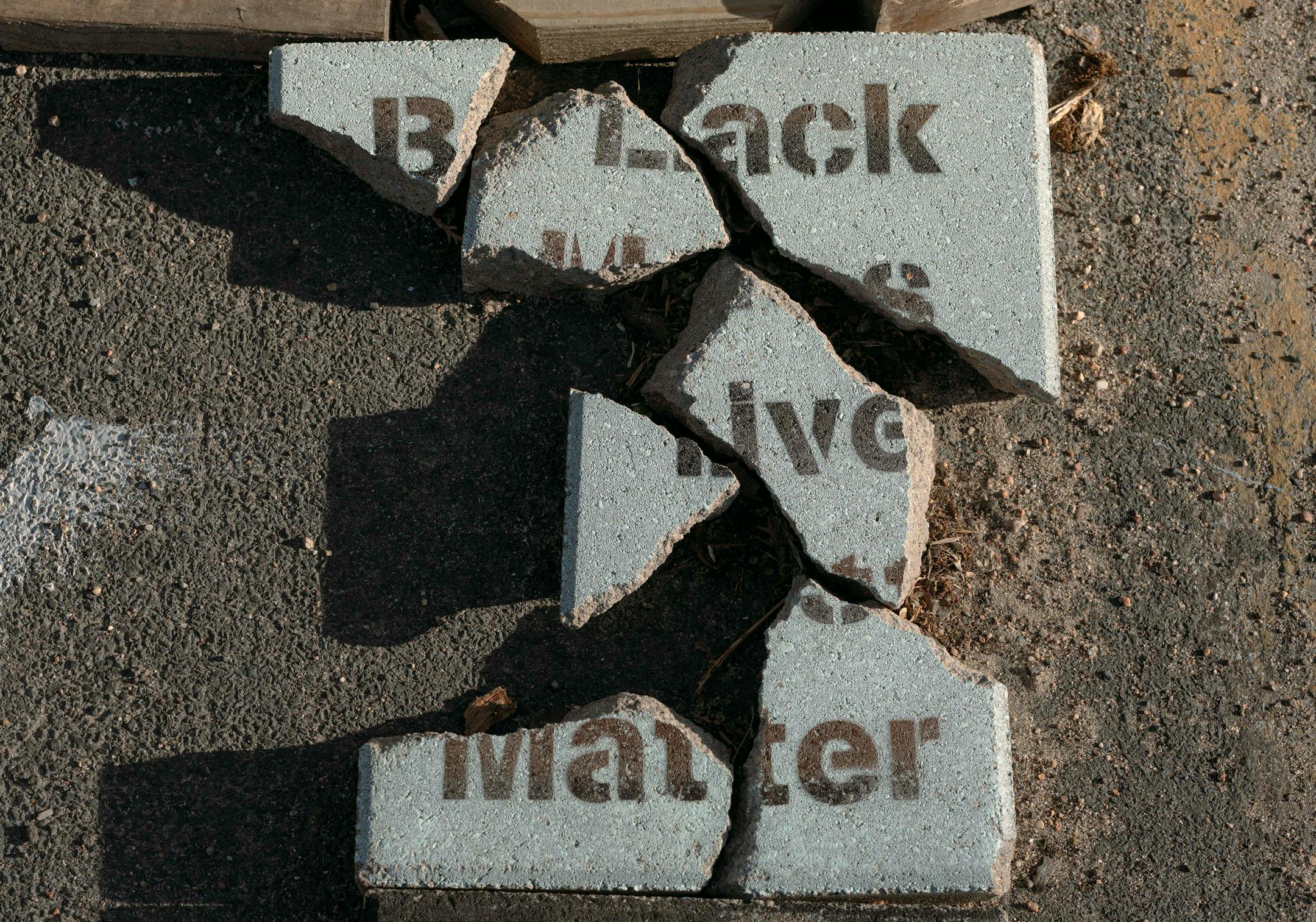 A shattered block at George Floyd Square in Minneapolis, May 14, 2022. Two years after George Floyd's murder, the street art created during that summer's uprising — and the hope it inspired — is fading away. (Ike Edeani/The New York Times)