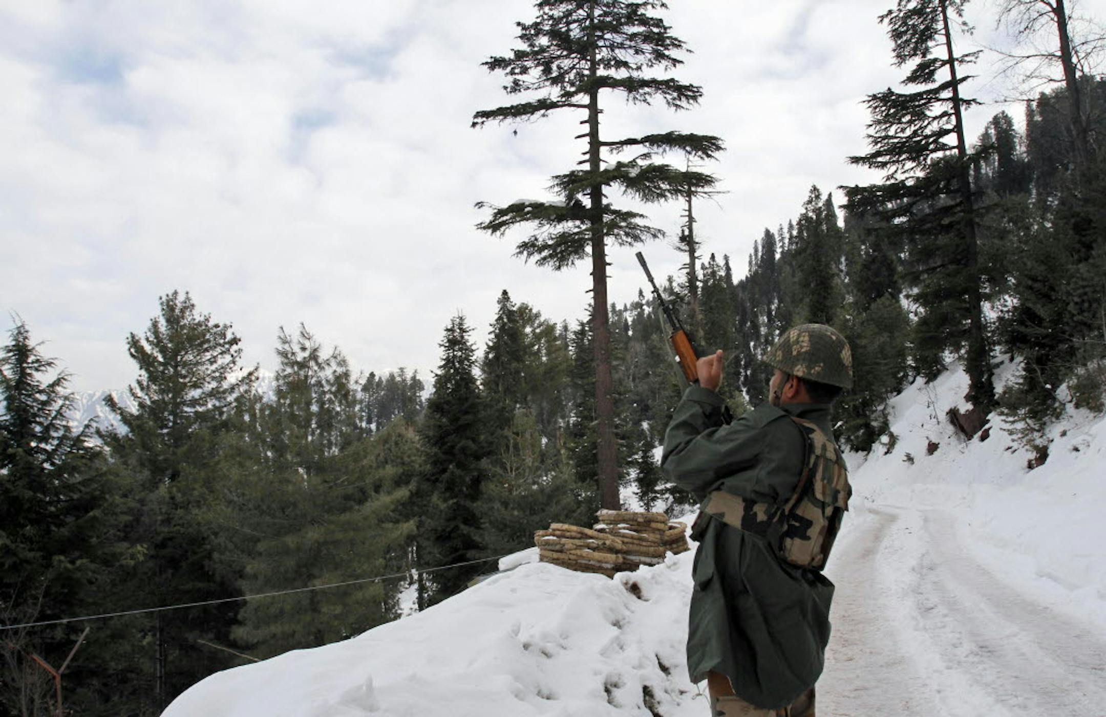 An Indian army soldier checks his rifle as he patrols near the line that divides Kashmir between India and Pakistan, in Churunda village, about 94 miles northwest of Srinagar, India.