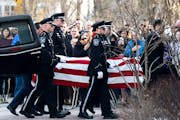 The Burnsville Police Honor Guard accompanied the casket of one of two fallen officers outside Ballard-Sunder Funeral and Cremation.
