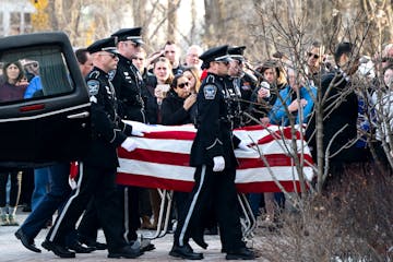 The Burnsville Police Honor Guard accompanied the casket of one of two fallen officers outside Ballard-Sunder Funeral and Cremation.