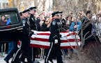 The Burnsville Police Honor Guard accompanied the casket of one of two fallen officers outside Ballard-Sunder Funeral and Cremation..