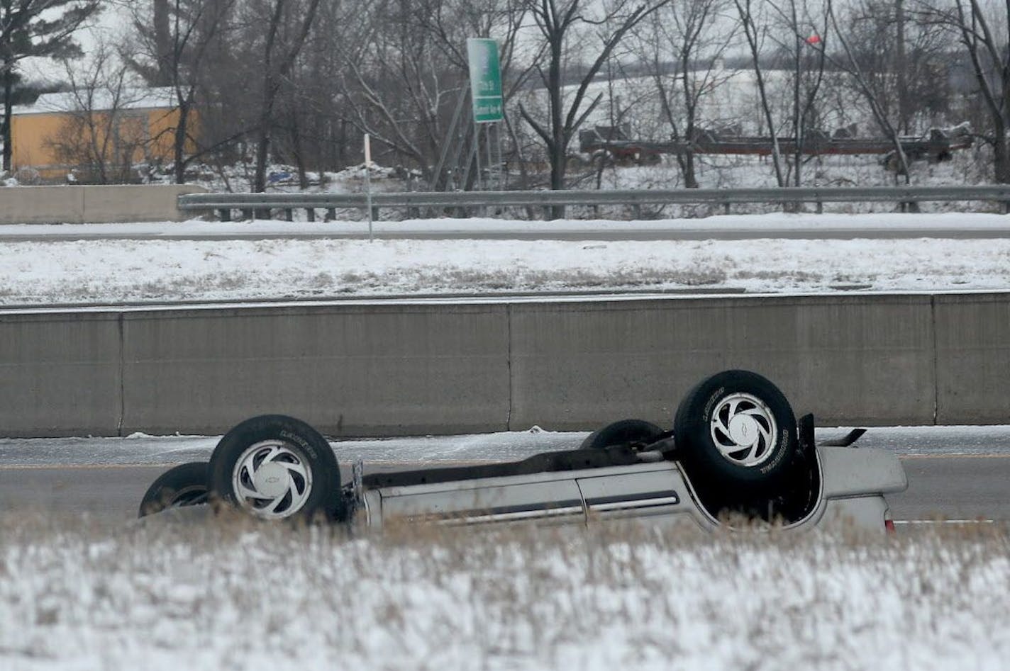 A coating of snow, plunging temps and high winds made driving conditions hazardous on metro roads, causing numerous spin outs and crashes early Saturday, March 31, 2018, including this roll over along Highways 61/10 in Cottage Grove, MN.